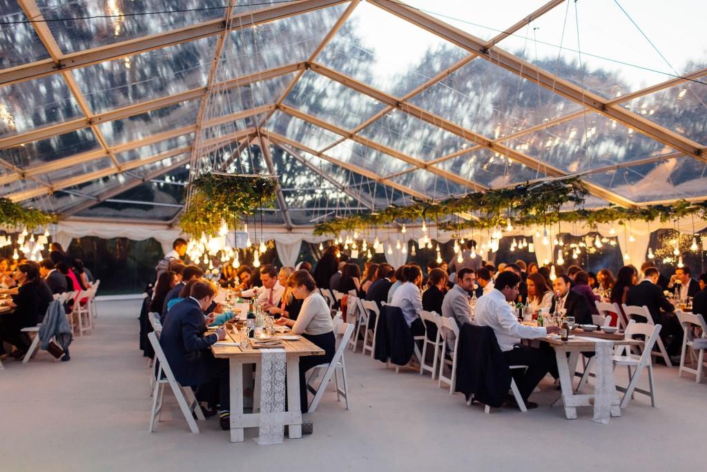 Elegant event space under a clear tent at Greenhaus, ideal for gatherings and corporate events.