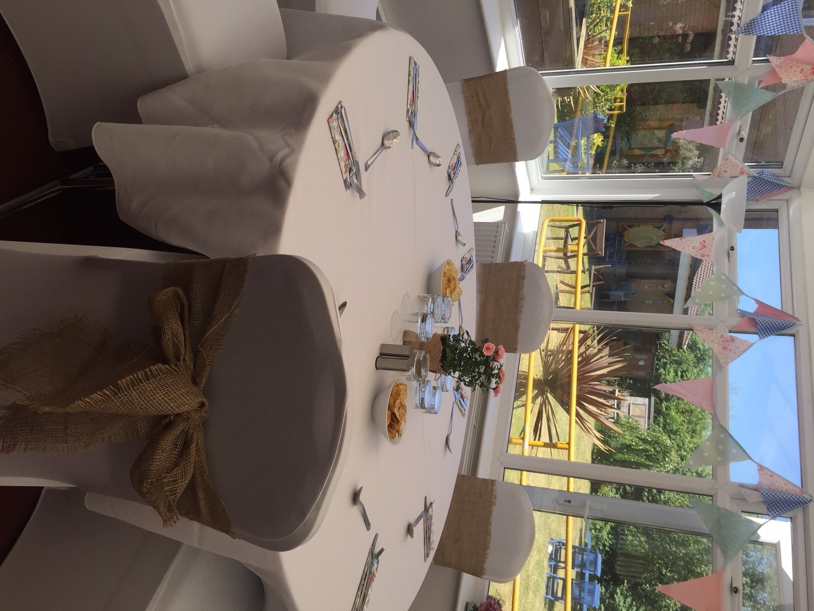 Iris Conservatory meeting setup with round table, snacks, and natural light ambiance.