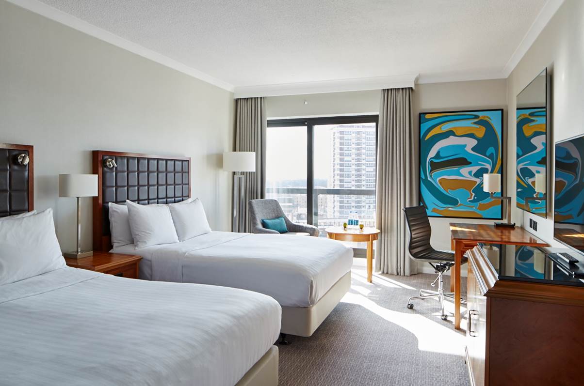 Westmacott Suite at London Marriott: twin beds, modern decor for business events.