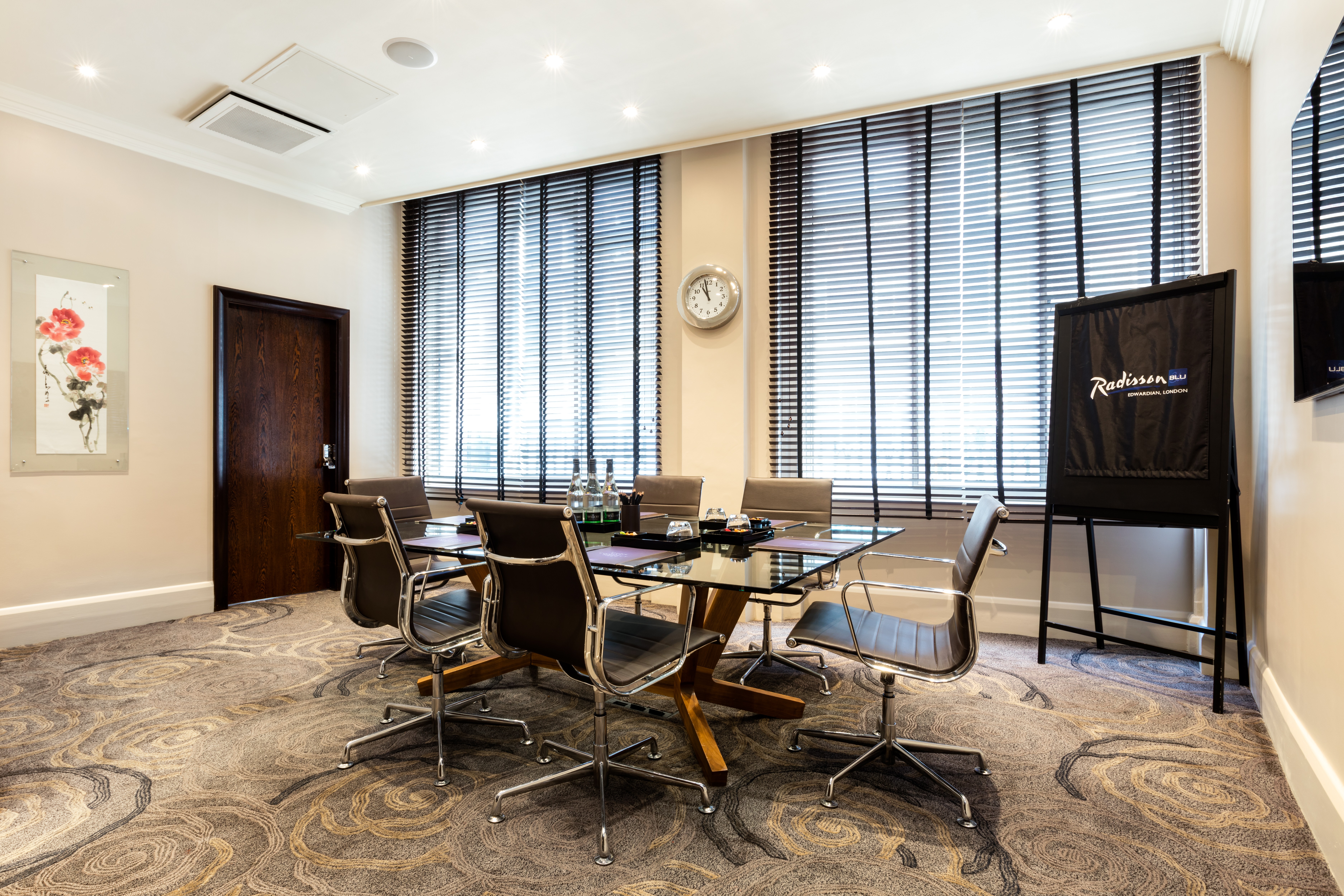 Private Room 8 at Radisson Blu, modern meeting space with glass table for corporate events.