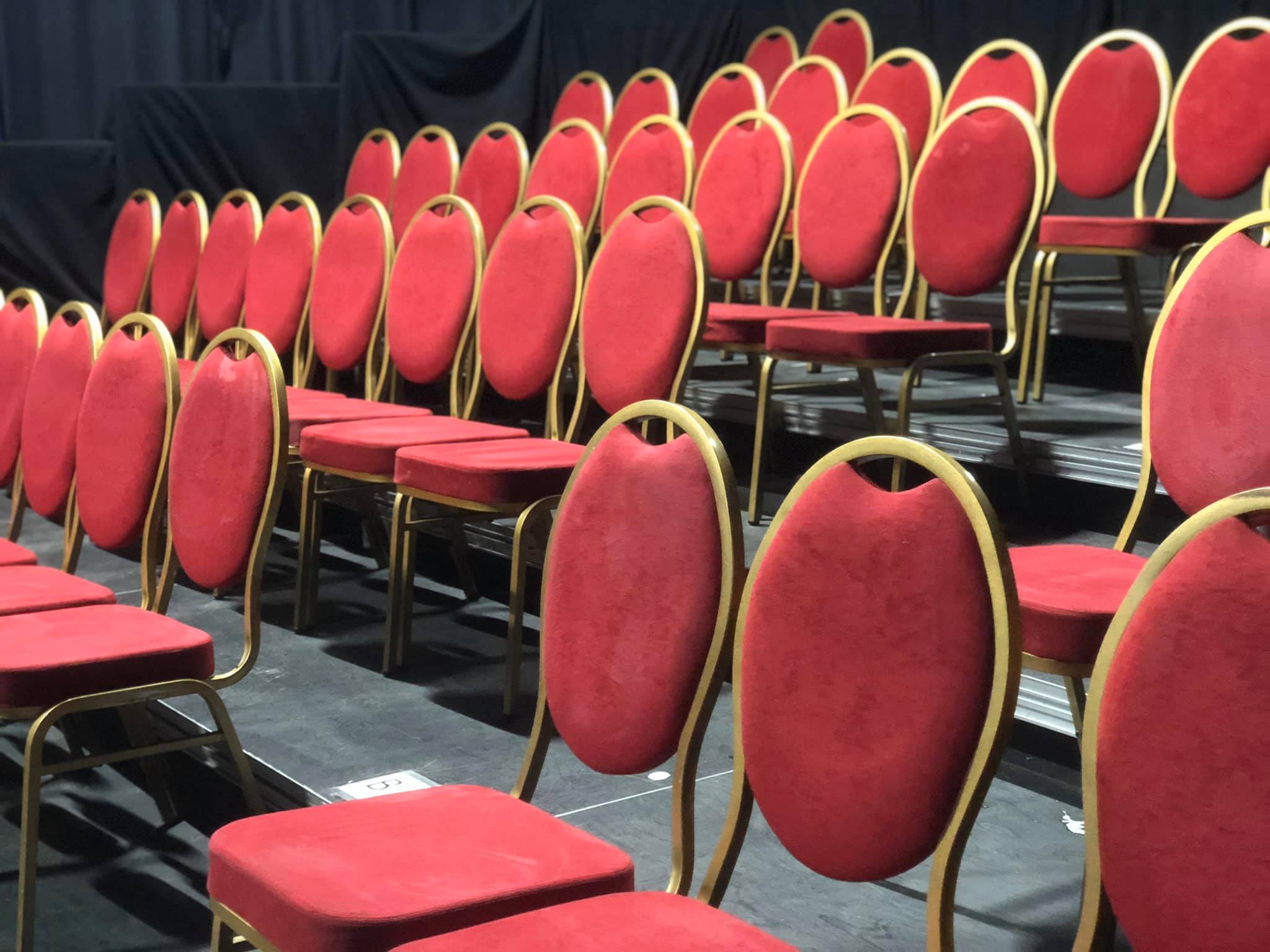Red tiered seating in The Empty Space, ideal for conferences and presentations.