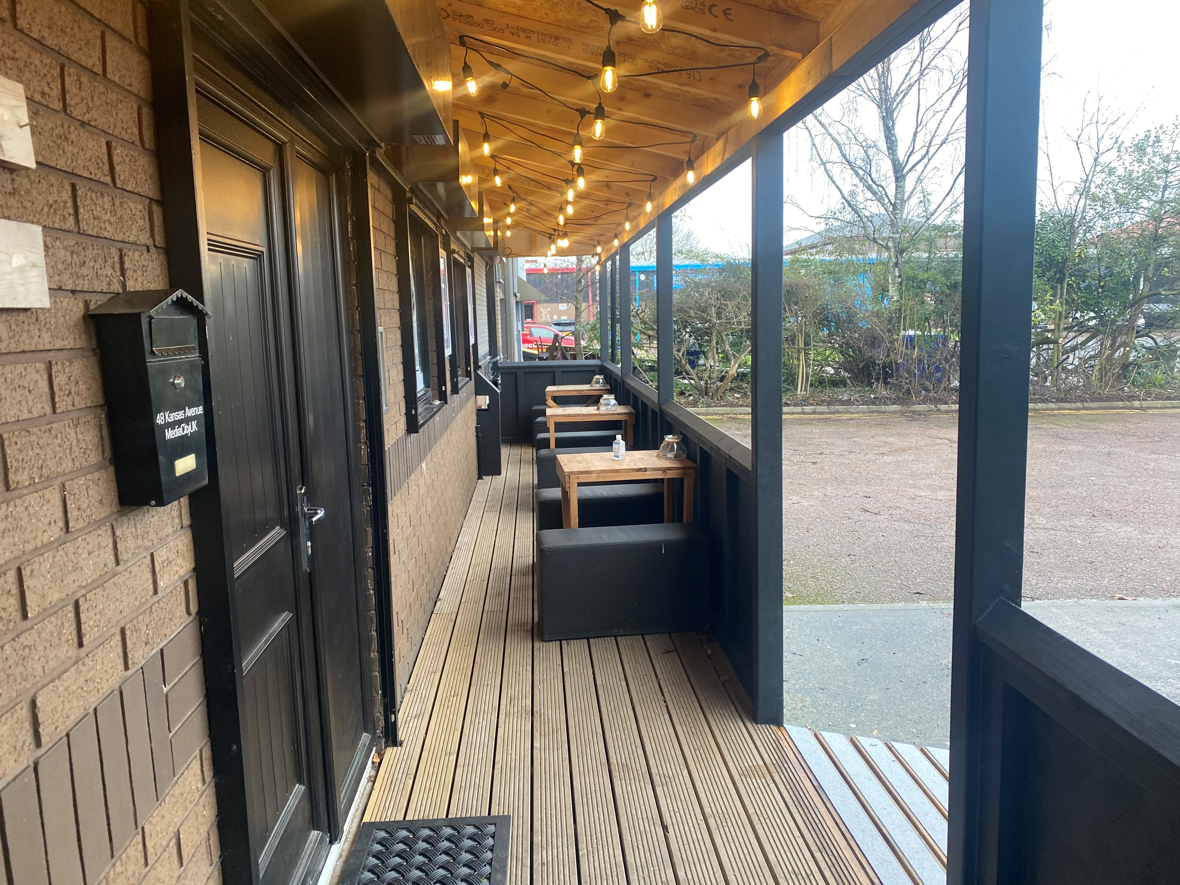 Charming outdoor venue with warm lighting for casual meetings and networking events.