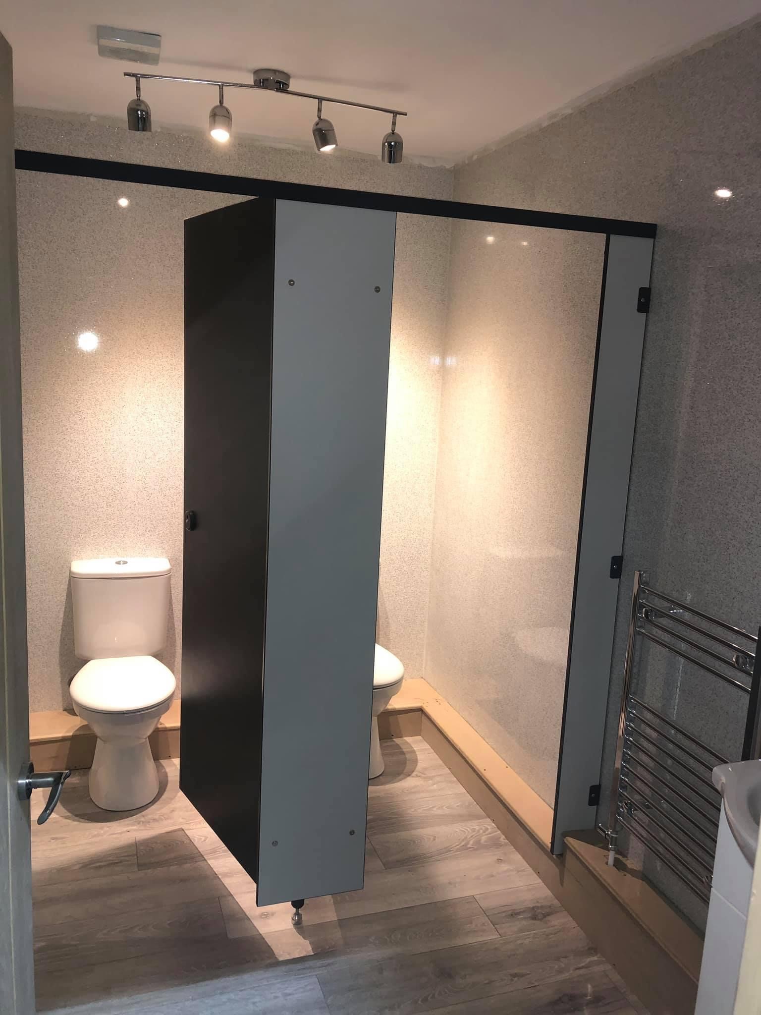 Modern restroom stalls in The Empty Space venue for events and meetings.