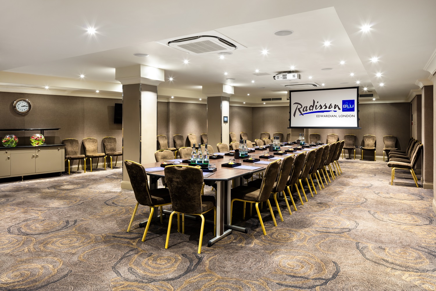 Corporate meeting room at Radisson Blu, featuring a long table and modern lighting.