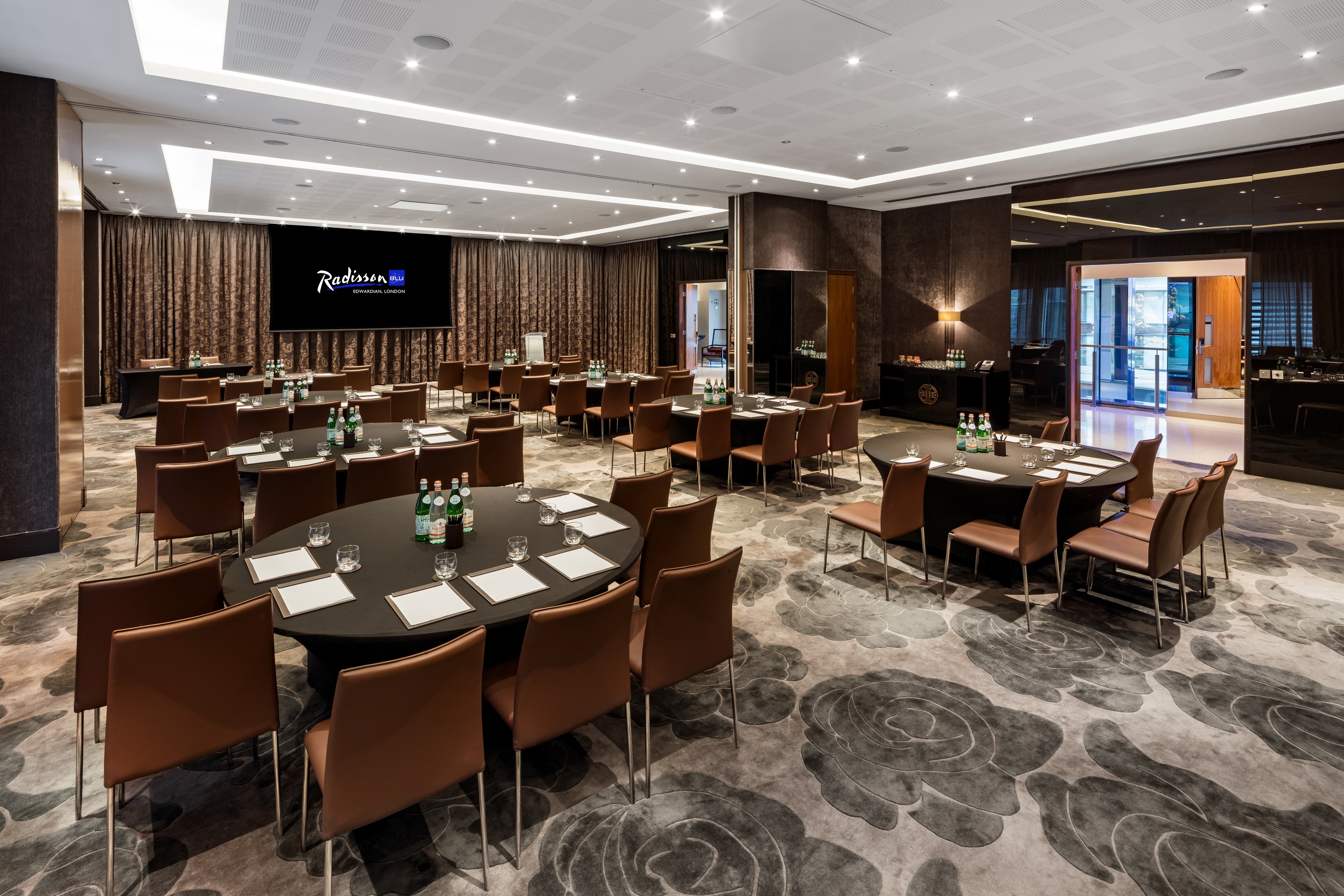 Ontario Room at Radisson Blu: modern meeting space for corporate events with round tables.