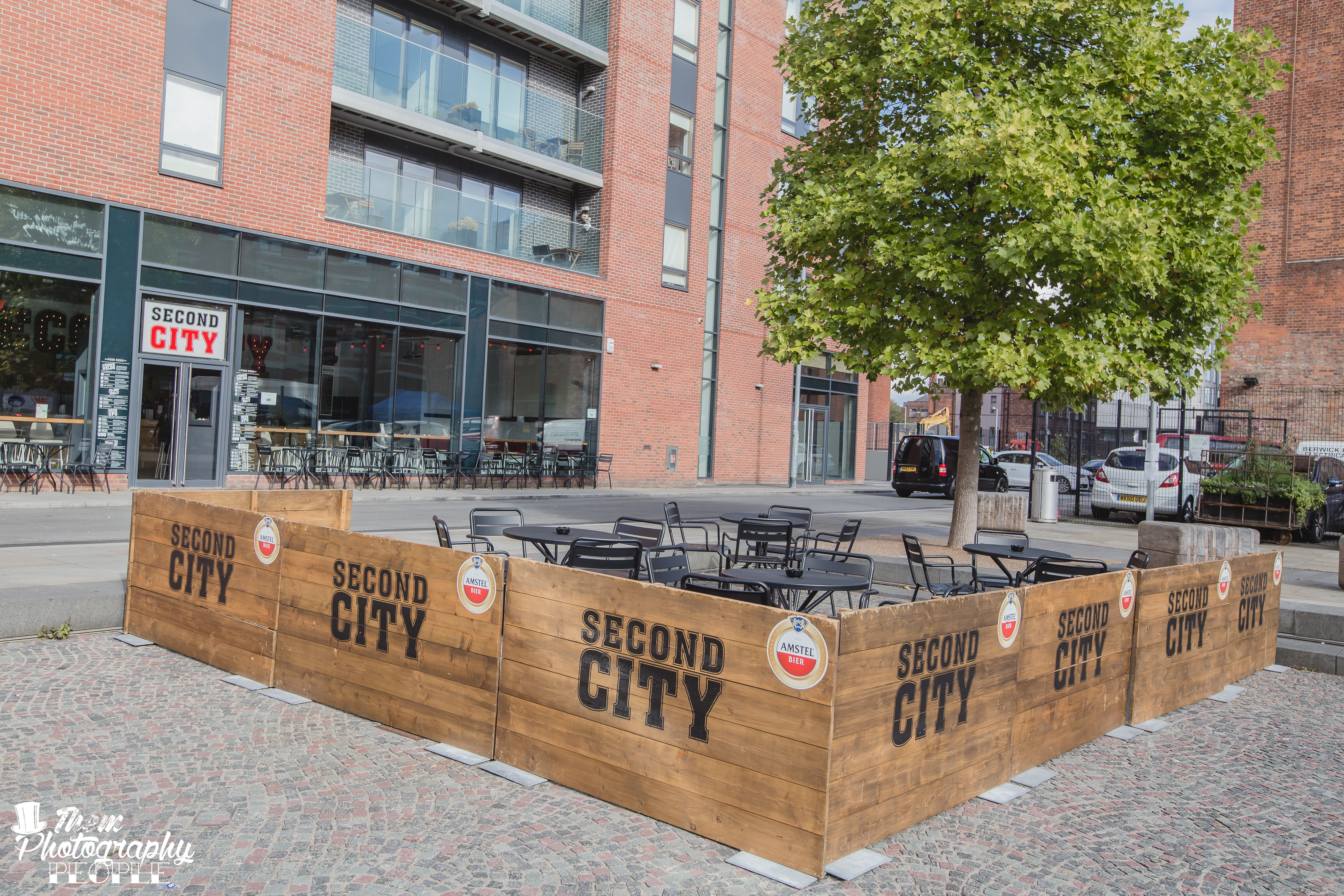 Outdoor event space at Second City with rustic wooden enclosure for gatherings.