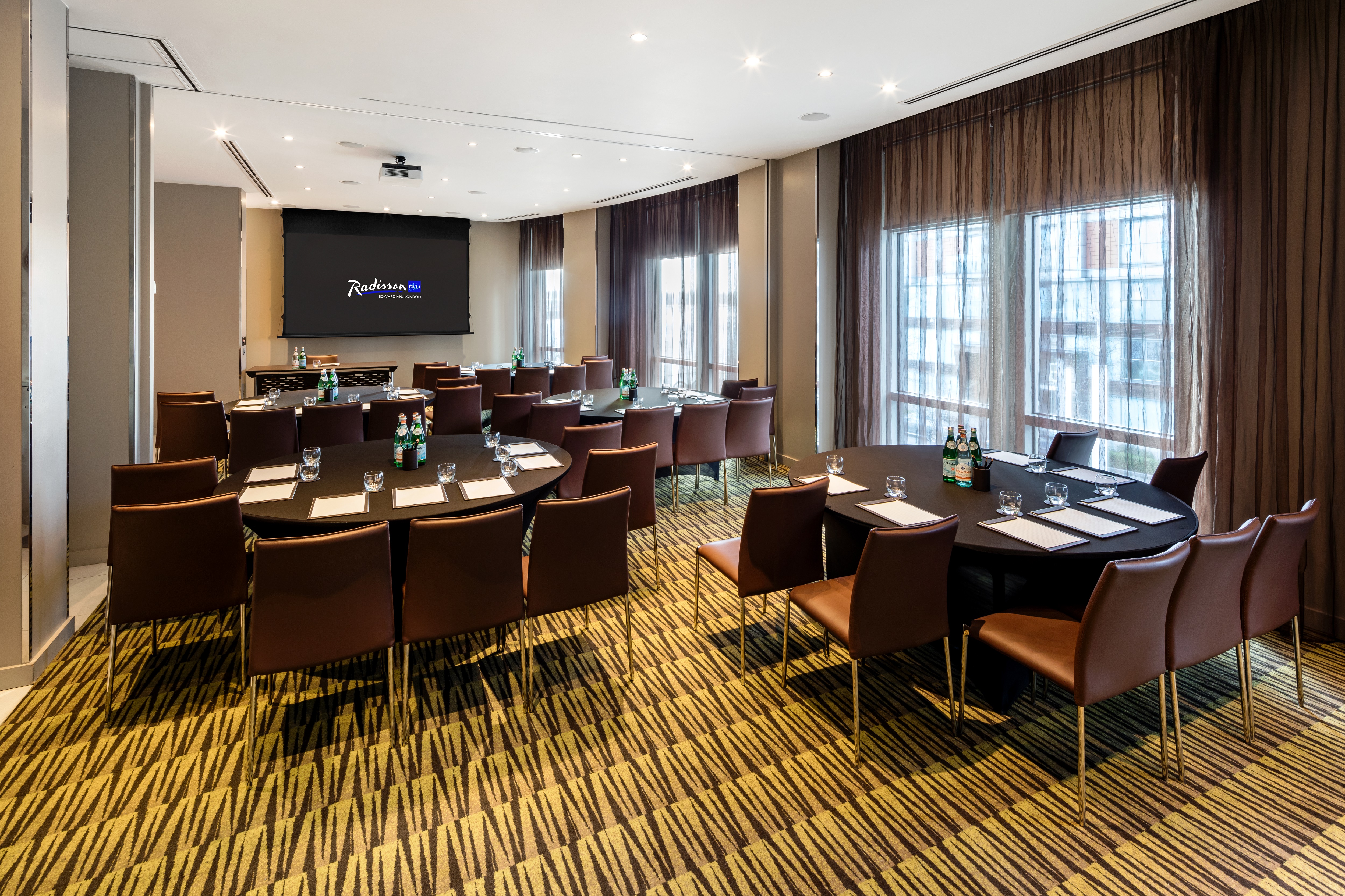 Private meeting room with oval table and natural light at Radisson Blu Edwardian.