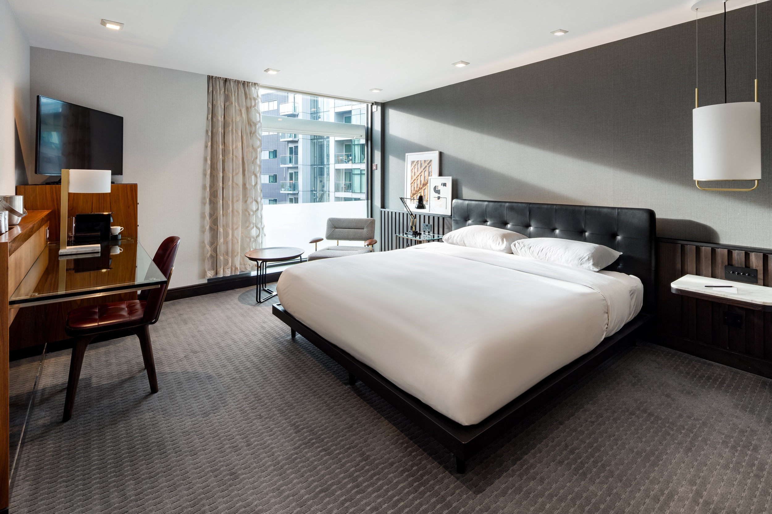 Modern hotel room with desk for business travelers at The Edwardian Manchester.