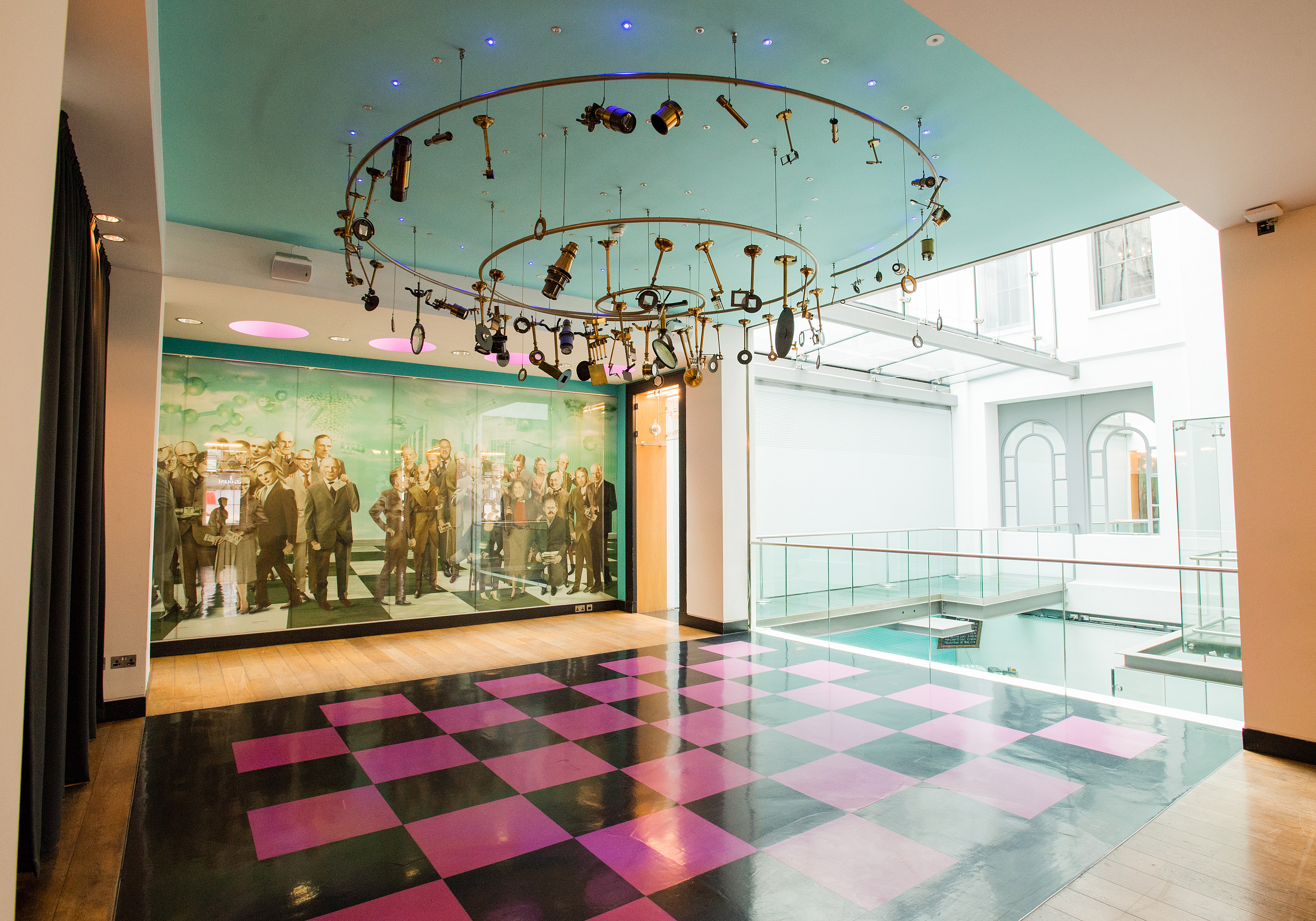 Modern event space with chandelier, ideal for corporate gatherings and social celebrations.