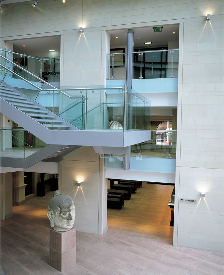 Modern atrium venue with glass railings for networking events in Edwardian Manchester.