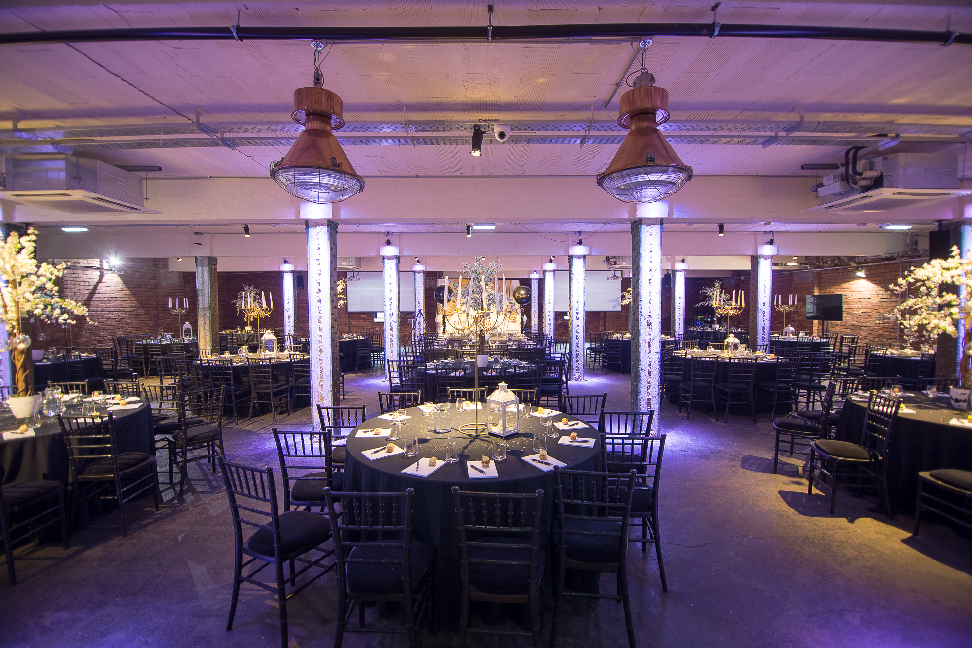 Elegant event space at The Cellars, Victoria Warehouse, set for a formal dinner.