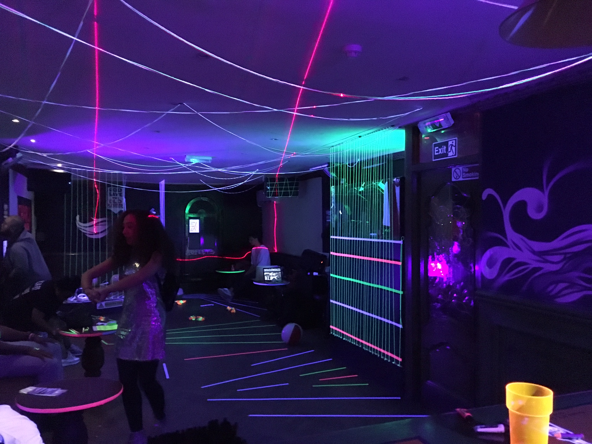 Vibrant event space at Moustache Bar Dalston with colorful laser lights for lively parties.