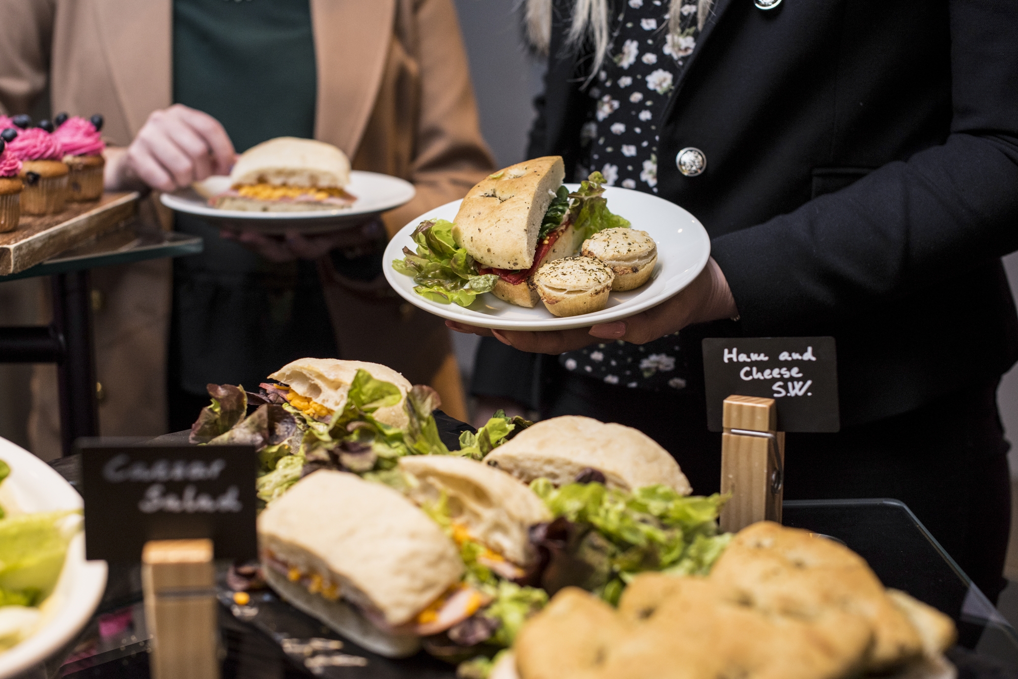 Buffet setup with sandwiches and salads for corporate event at Aloft London ExCeL.