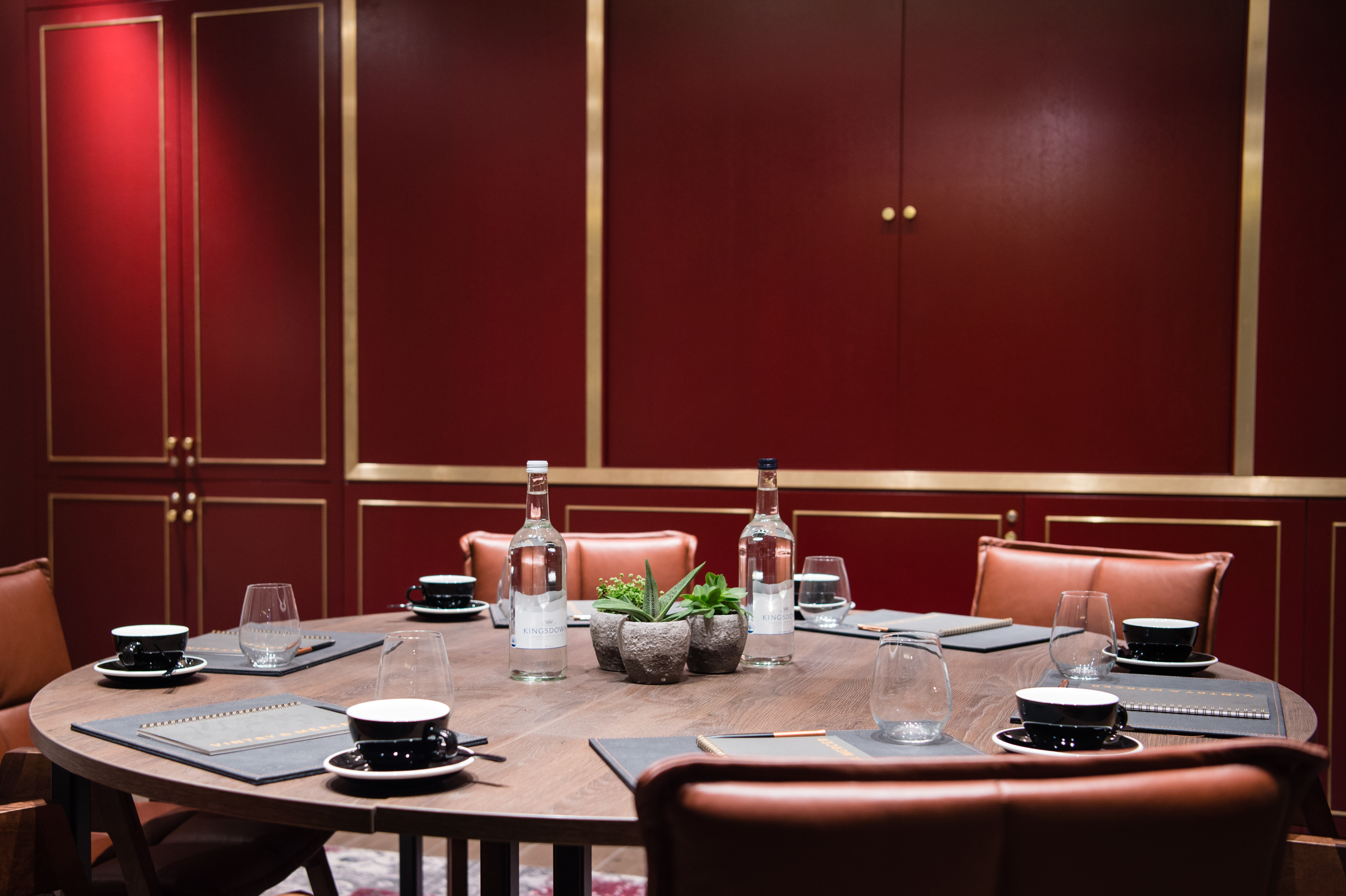 Sophisticated meeting room with round table and leather chairs at Vintry and Mercer Hotel.