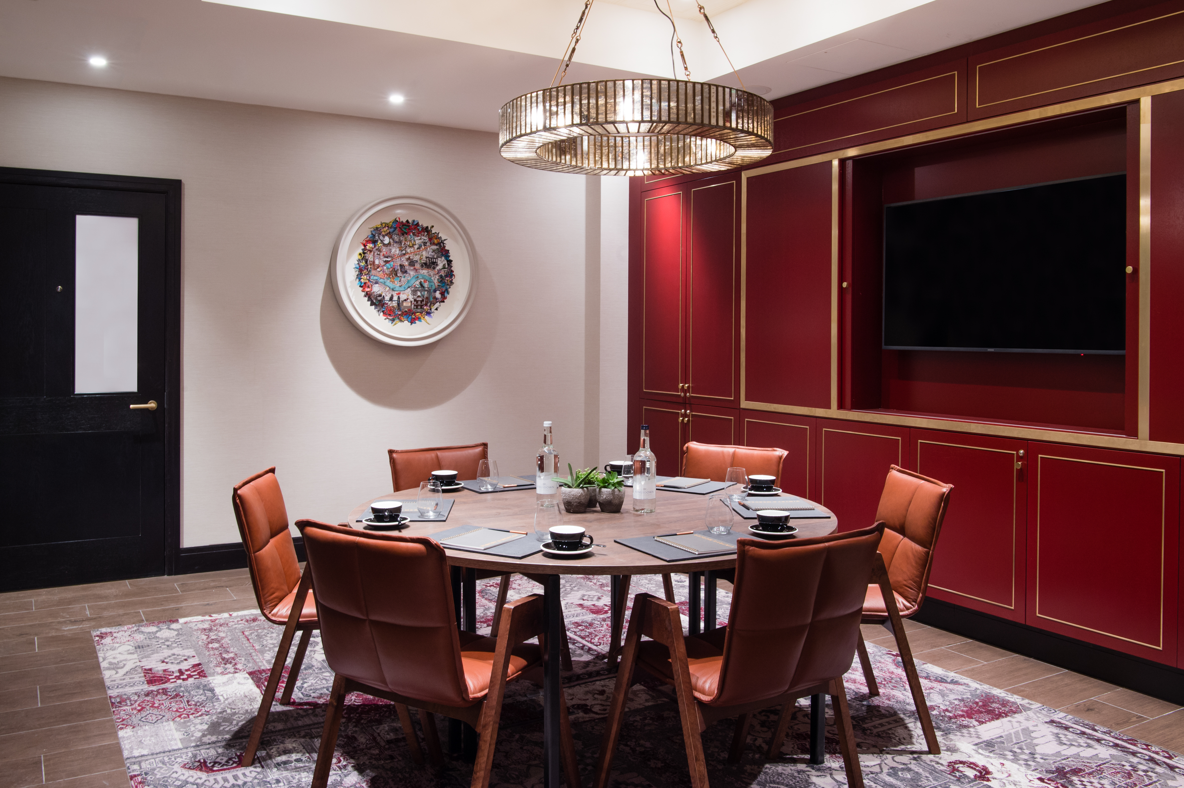 Stylish meeting room with round table at Vintry and Mercer Hotel for corporate events.
