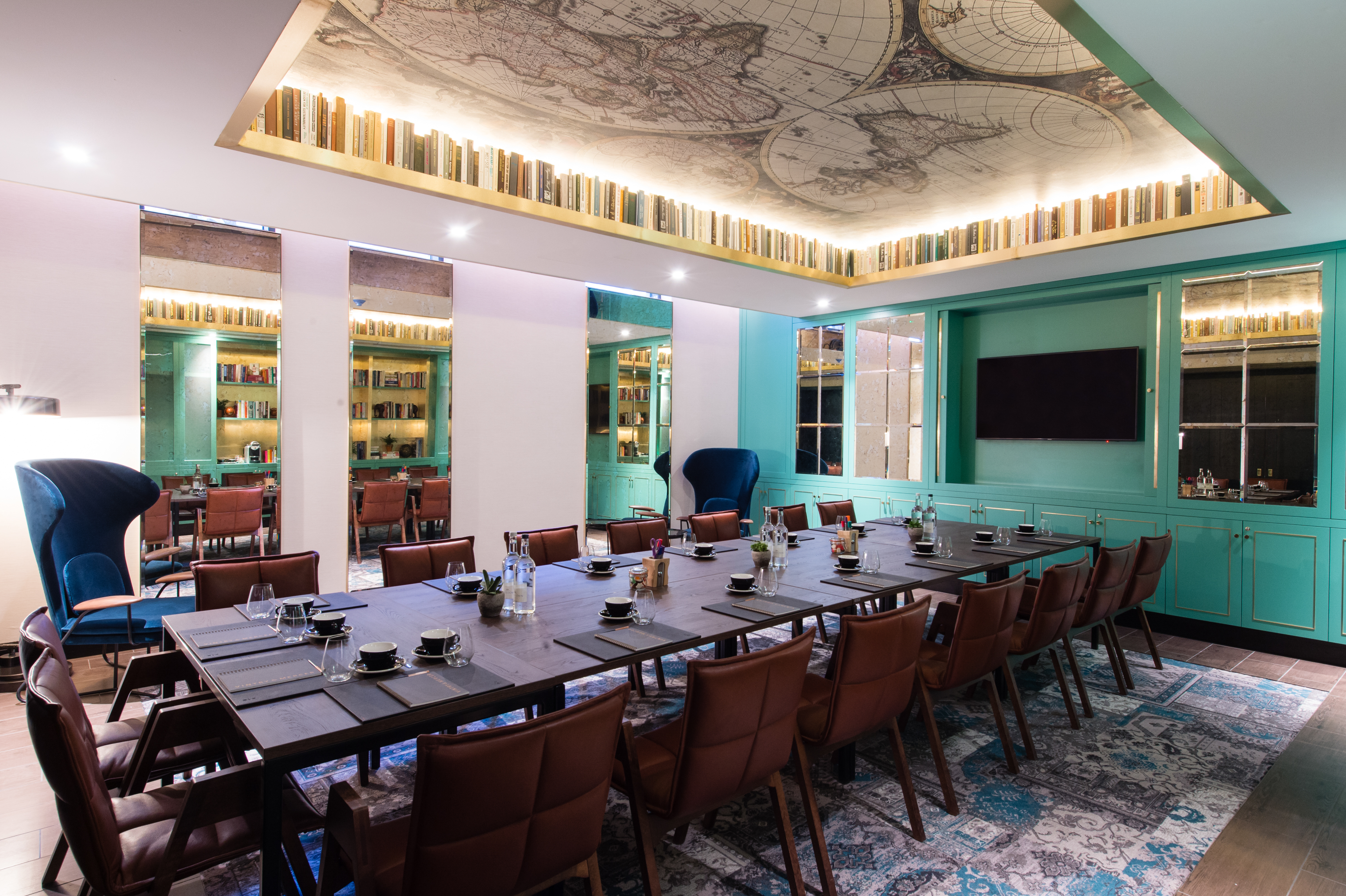 Sophisticated meeting room at Vintry and Mercer Hotel with map-themed ceiling, ideal for events.