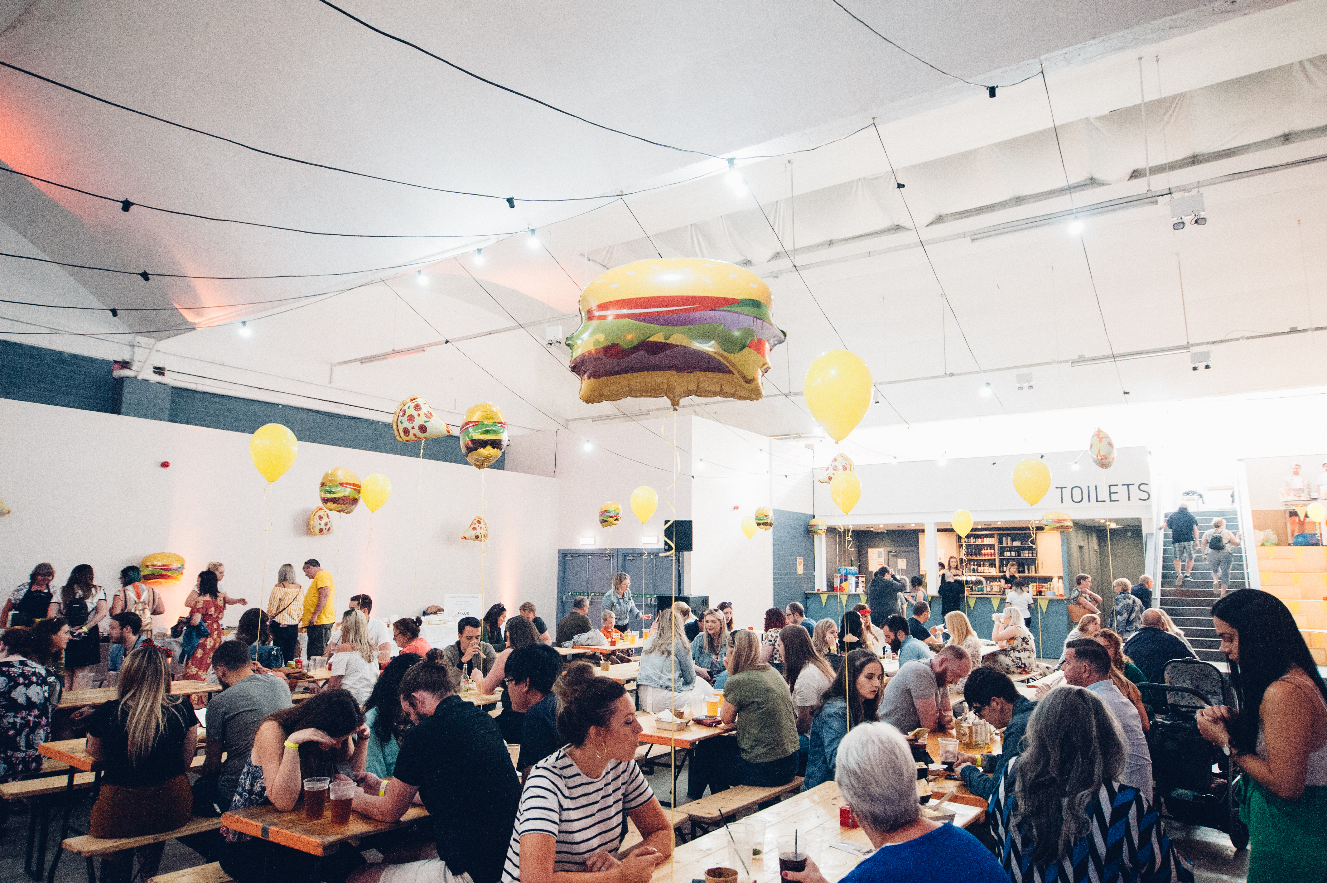 Vibrant event hall in Hinterlands with playful decor, perfect for casual dining and gatherings.