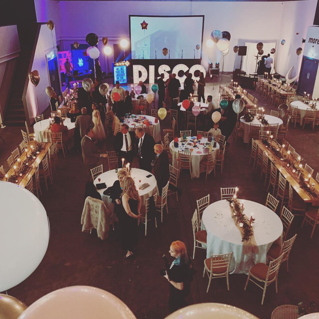 Elegant event hall in Hinterlands with candlelit tables, perfect for networking or celebrations.