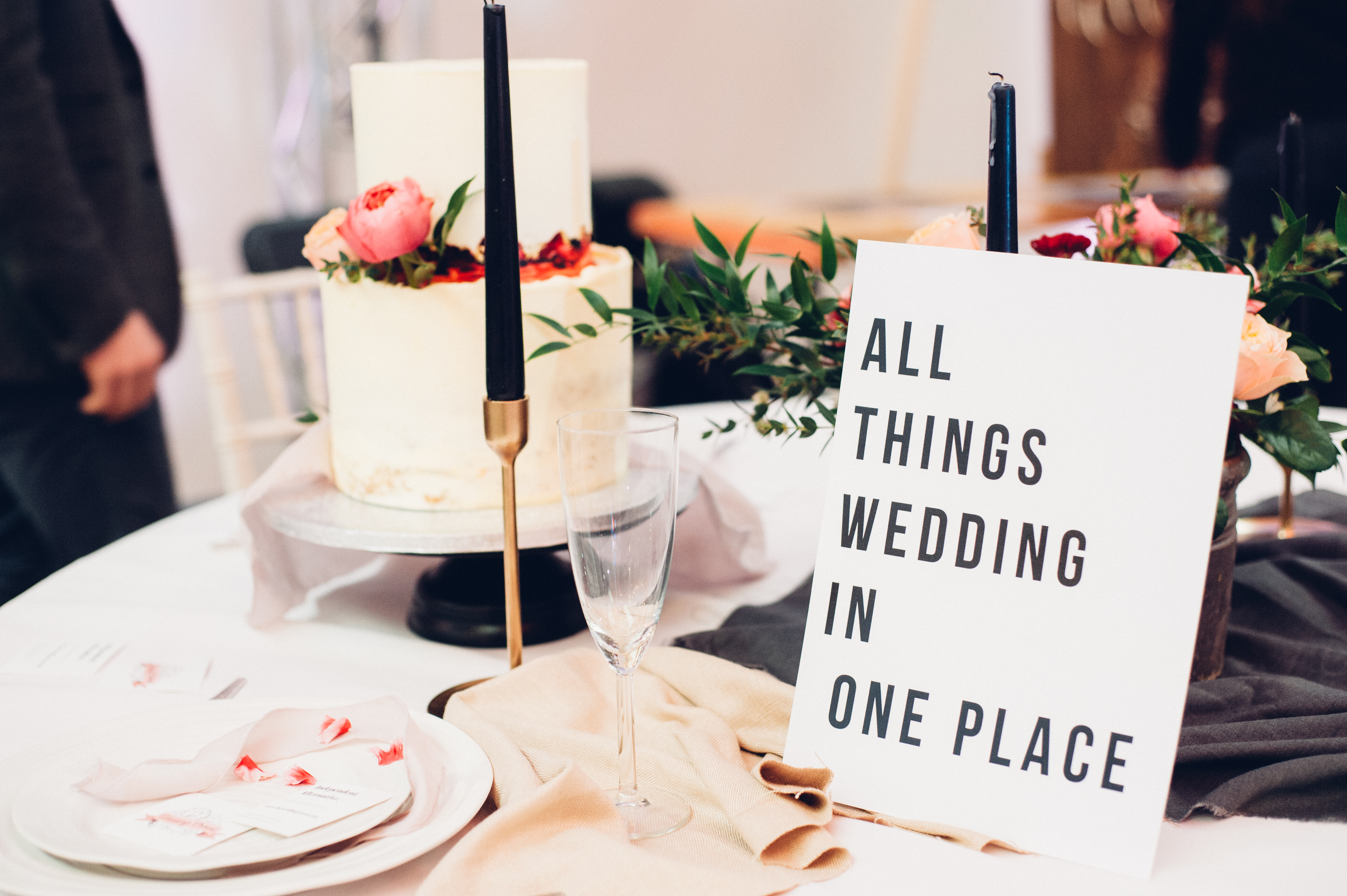 Elegant wedding tabletop setup with cake and candles in Hinterlands Event Hall.