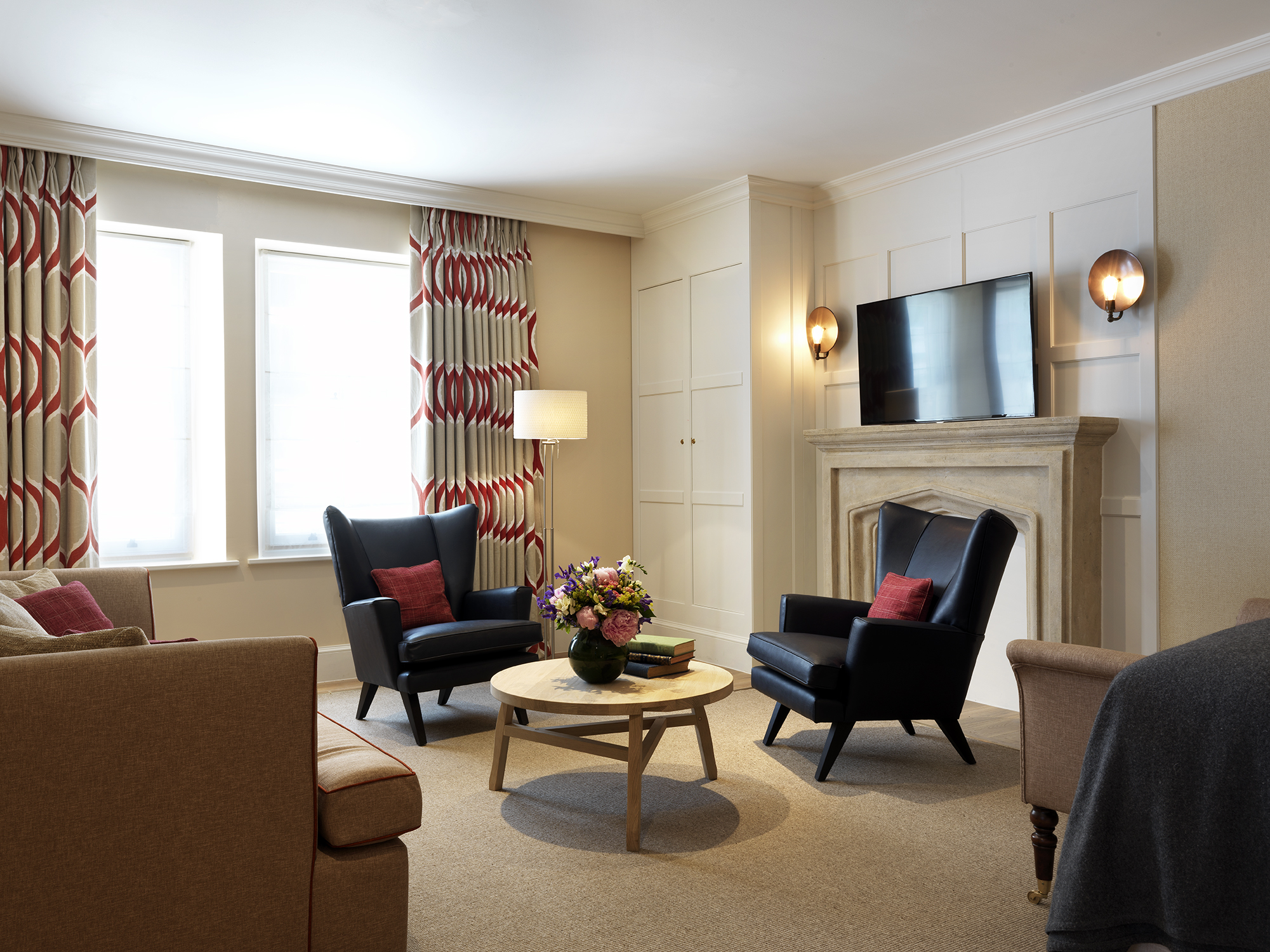 The Gatehouse meeting space in The Stafford London, featuring cozy seating and natural light.