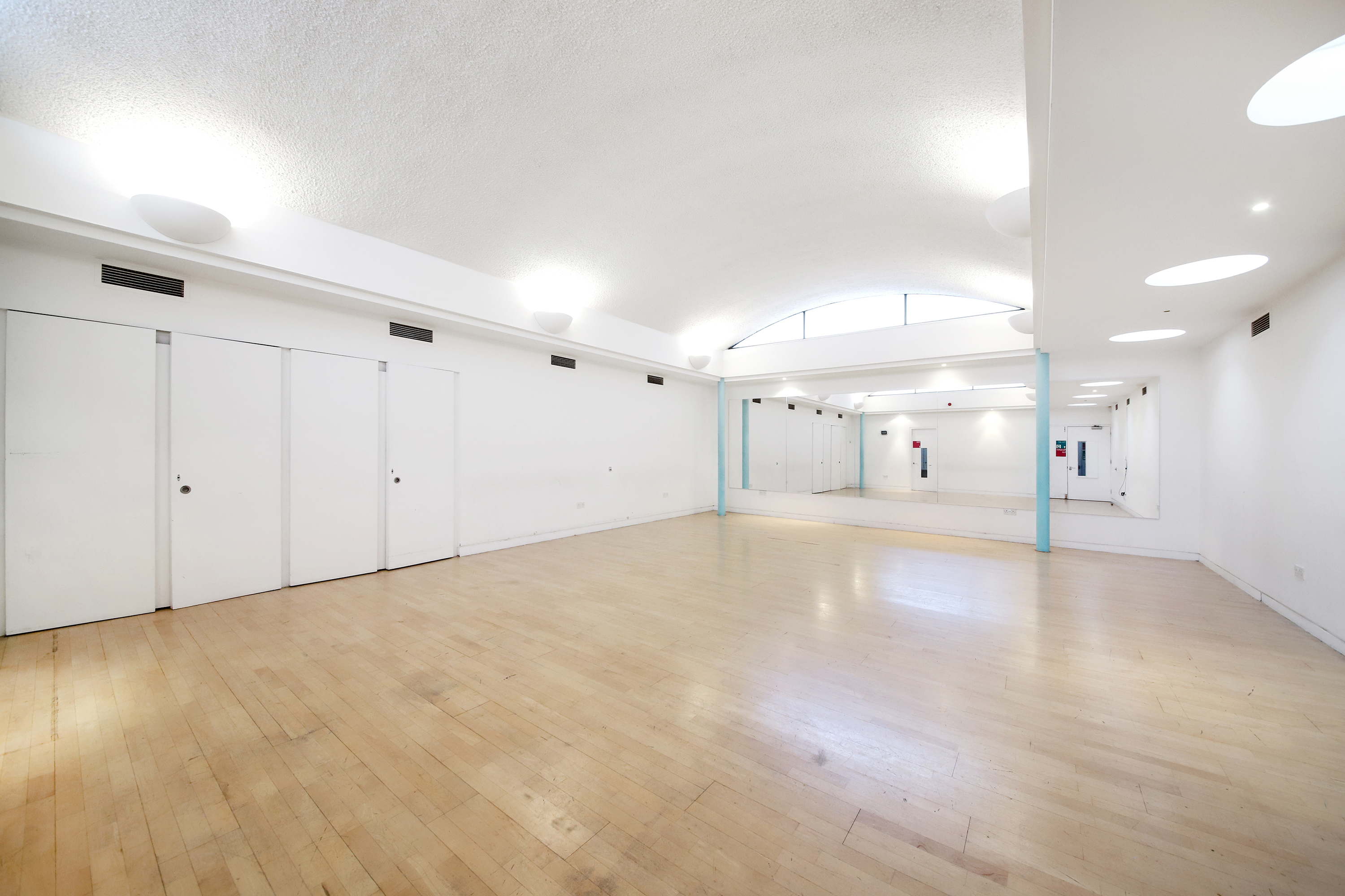 Spacious, well-lit event venue with minimalist design for workshops and gatherings.