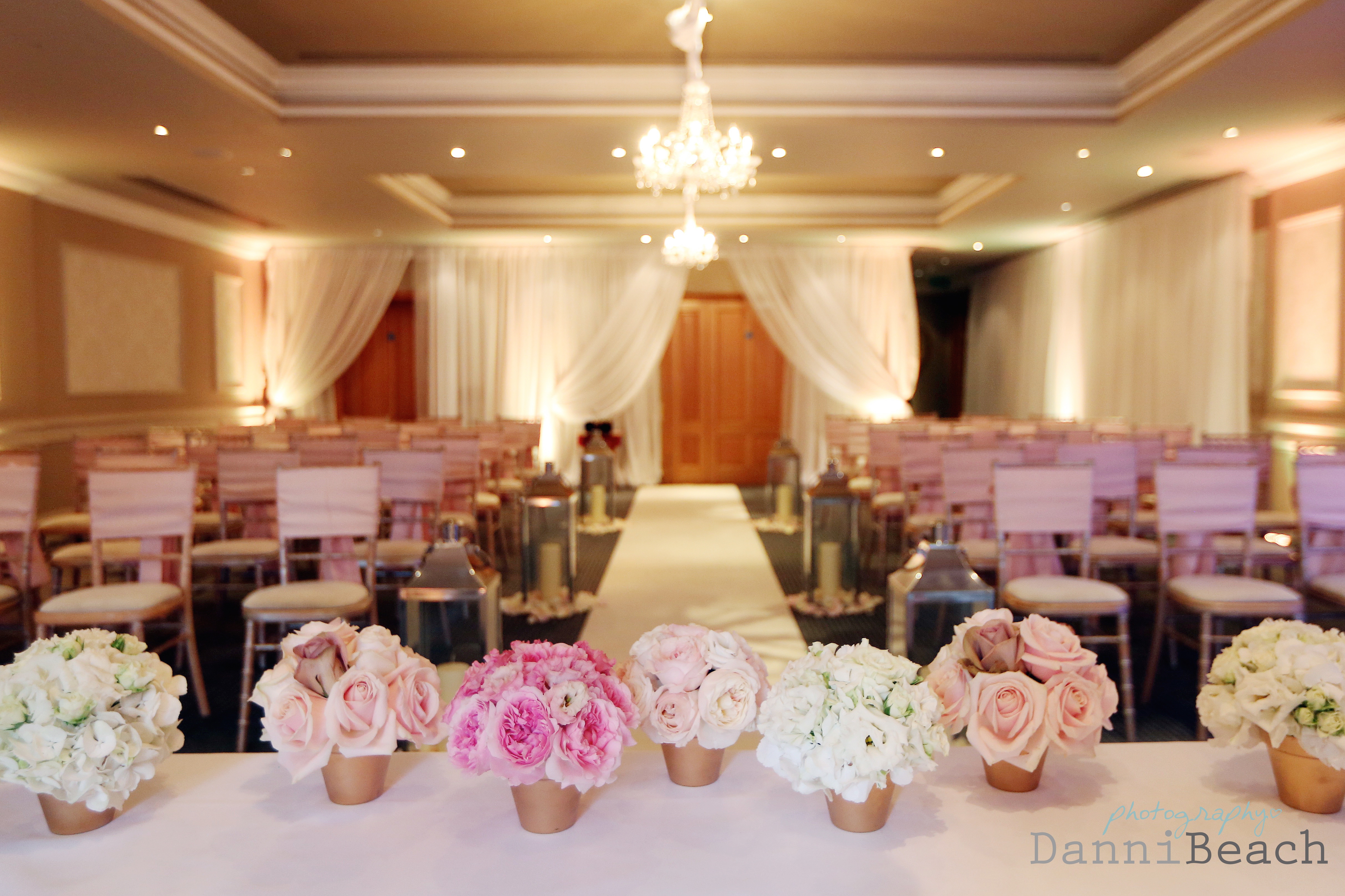 Elegant wedding venue in The Shelley Suite, featuring soft lighting and floral centerpieces.