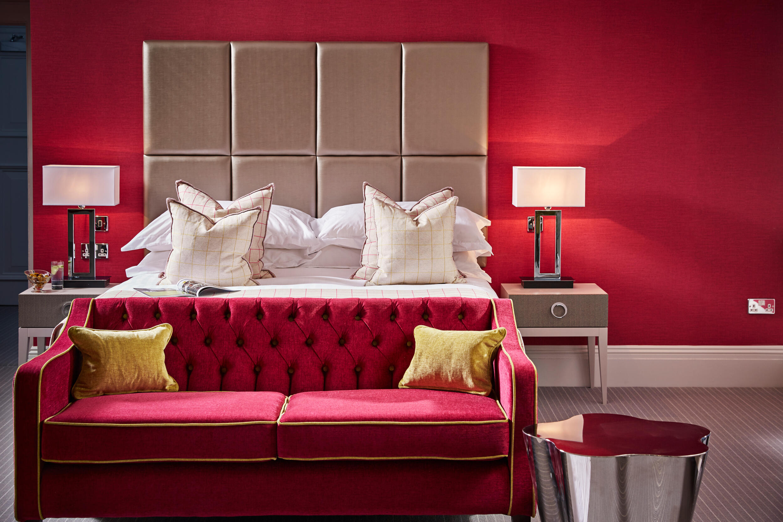 Luxurious Garden Suite at Barnett Hill Hotel with red accent wall, perfect for events.