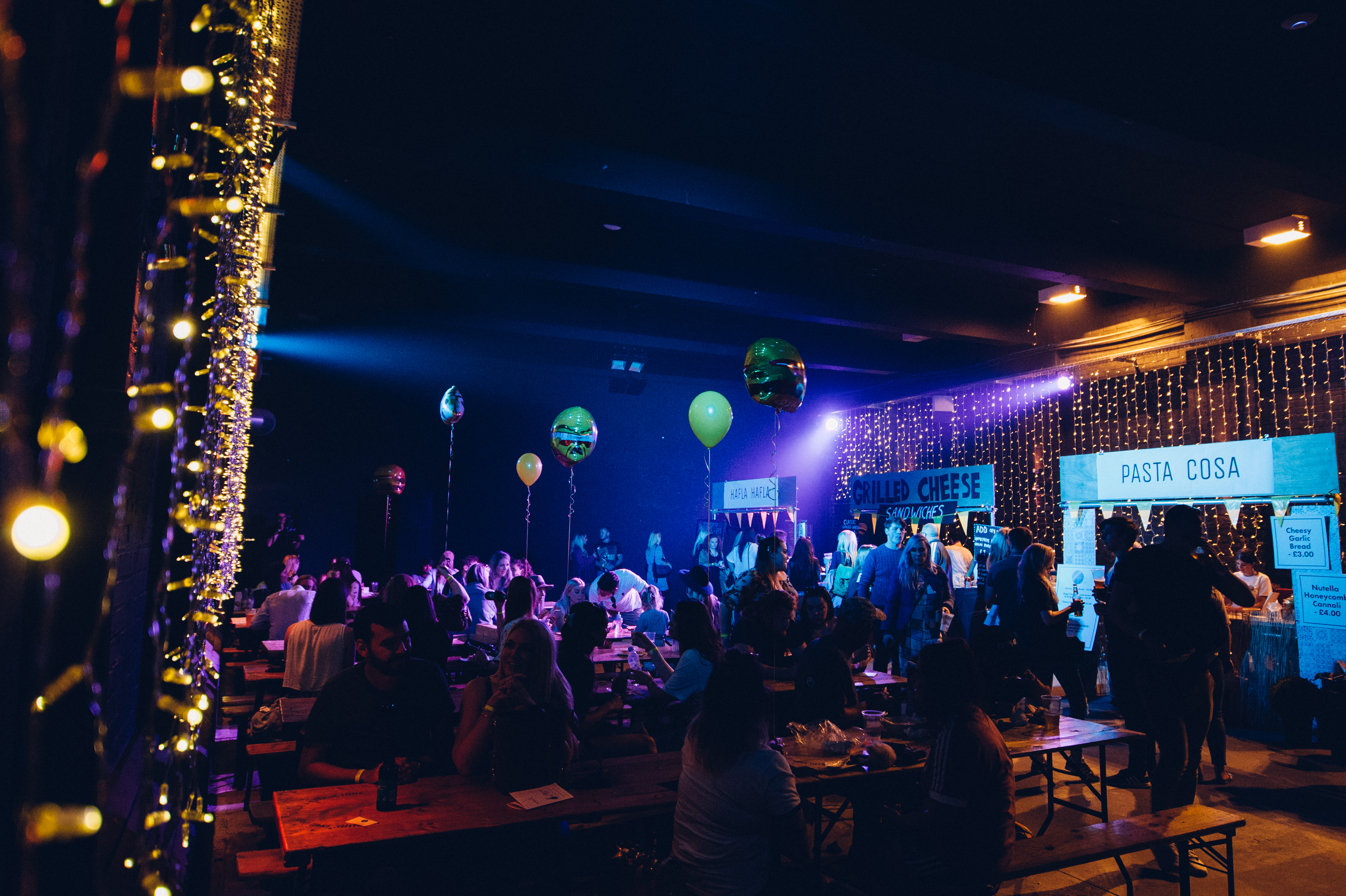 Eclipse Theatre event space with twinkling lights and colorful balloons for networking.