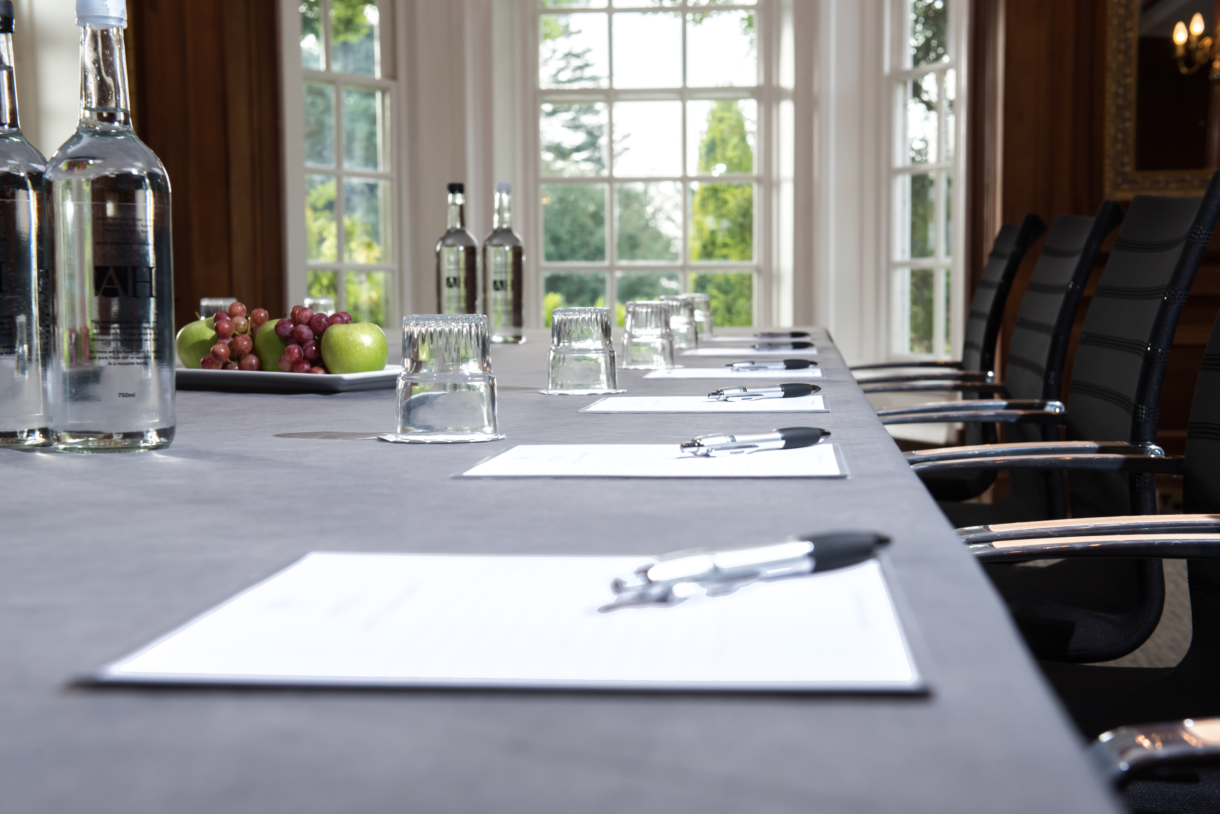 Meeting room at Barnett Hill Hotel with sleek table, ideal for conferences and events.