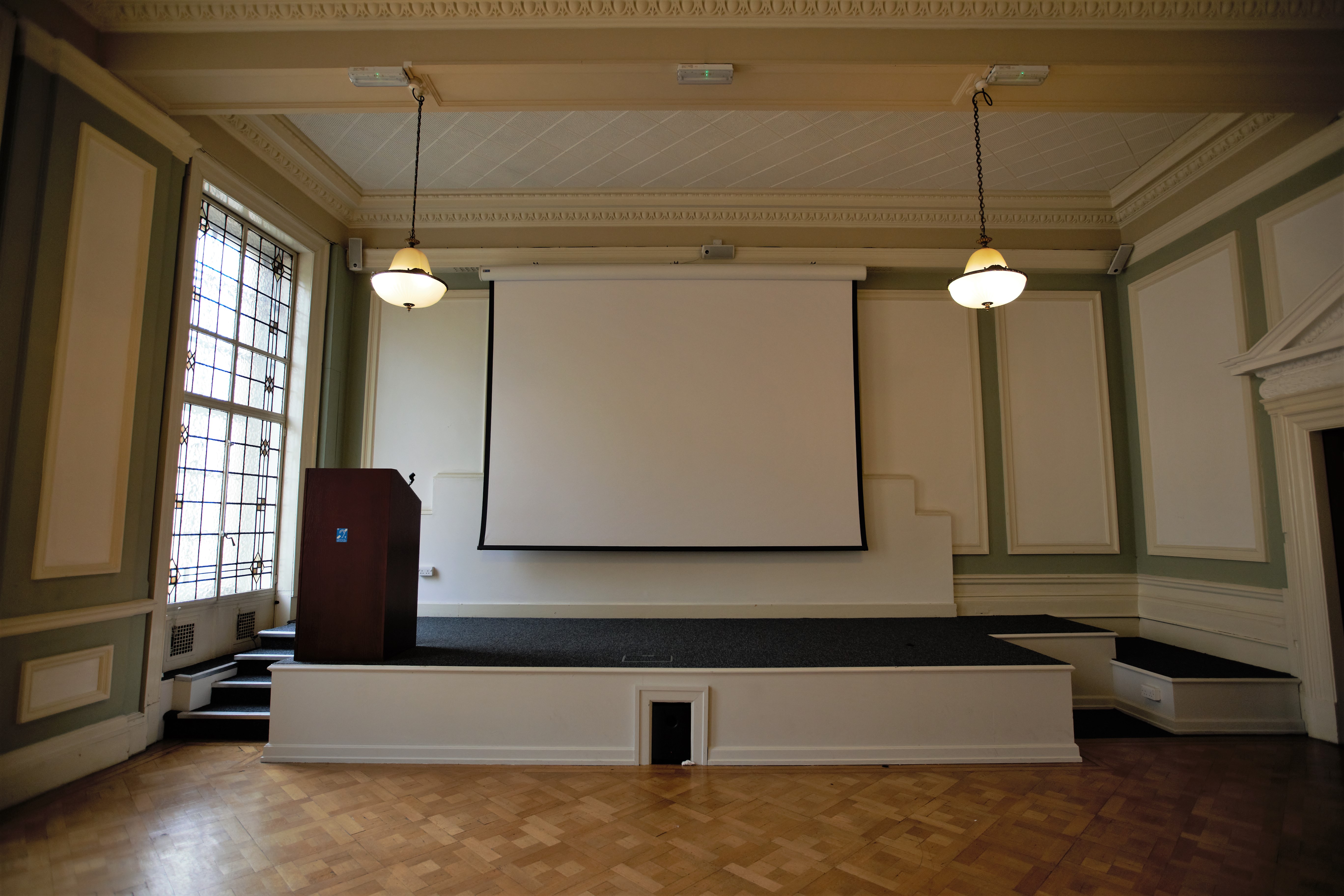 Chamber Hall event space with raised stage, ideal for presentations and meetings.