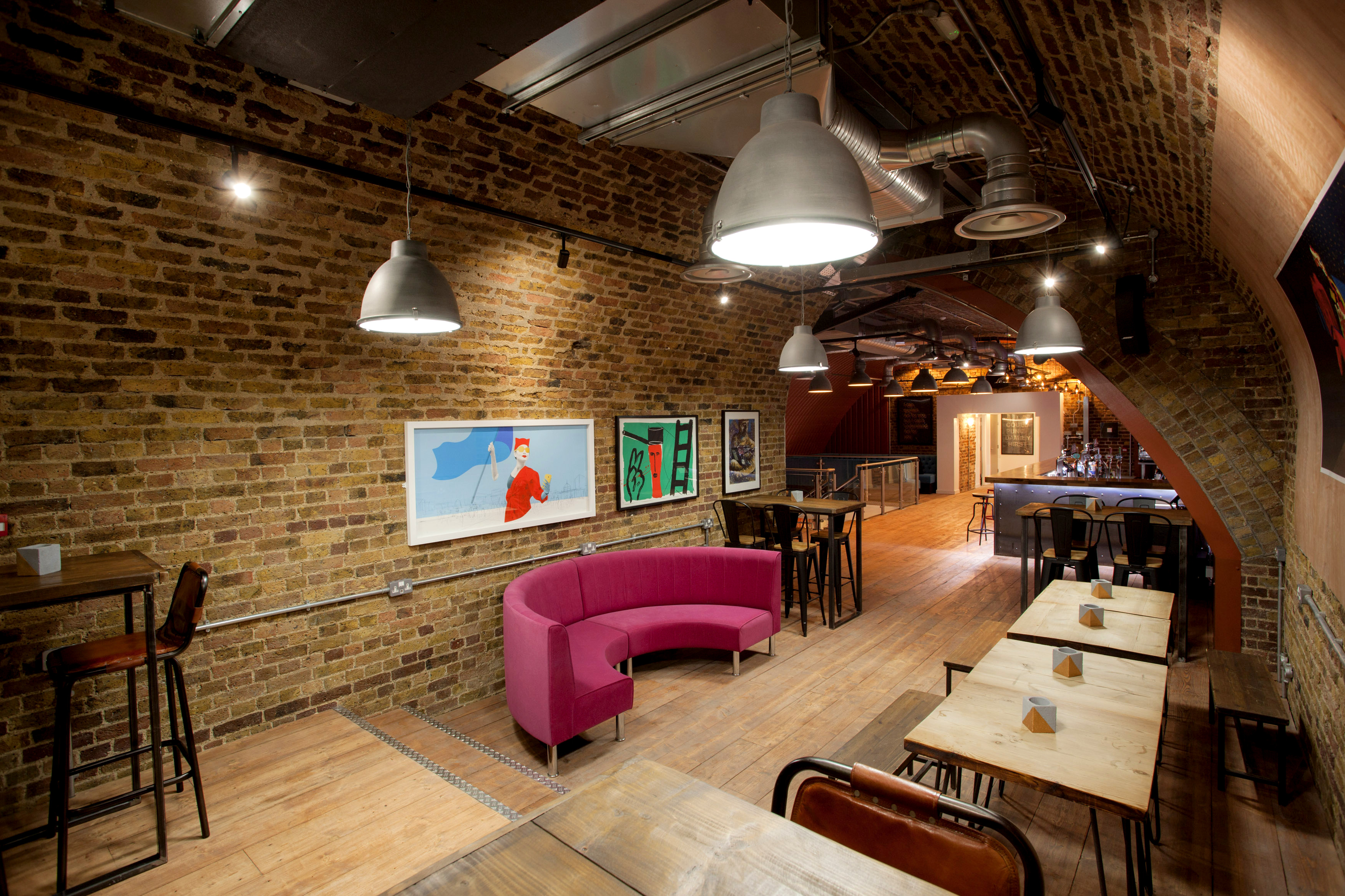 Stylish Upper Arch event space with exposed brick, ideal for networking and gatherings.