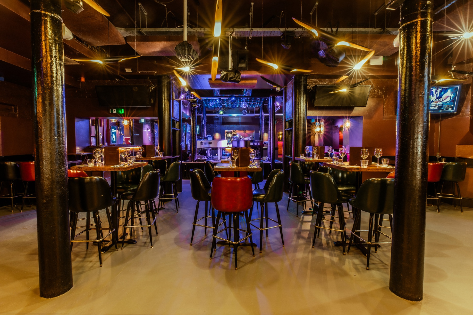 Versatile event space at The Piano Works Farringdon with high-top tables for networking.