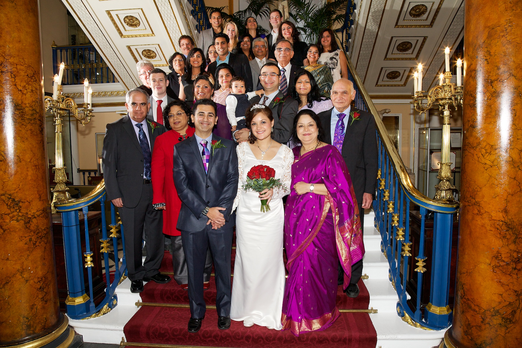 Wedding group photo in Liverpool Town Hall's elegant Main Ballroom, showcasing decor and inclusivity.