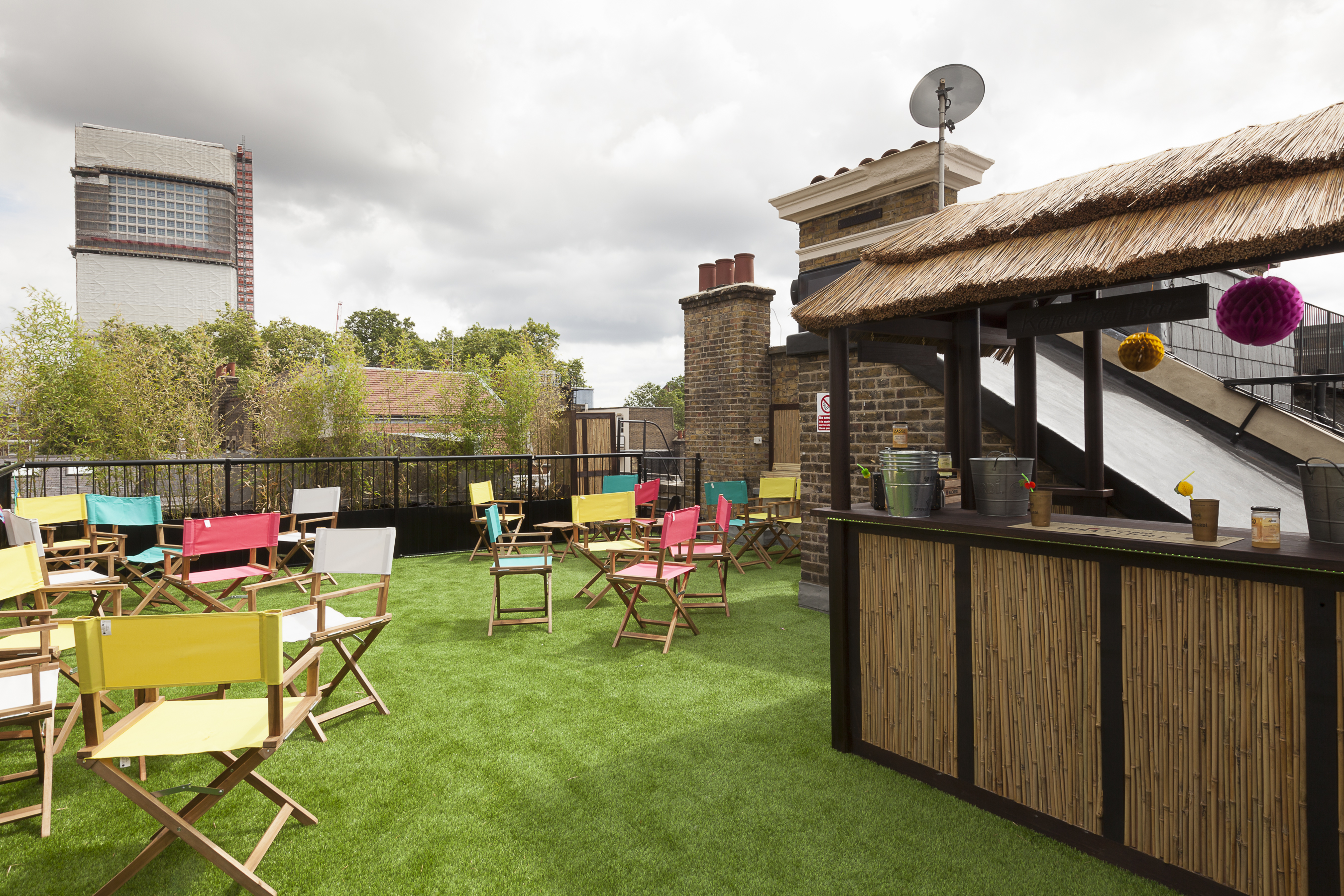 Vibrant rooftop event space with tiki bar, ideal for summer gatherings and networking.