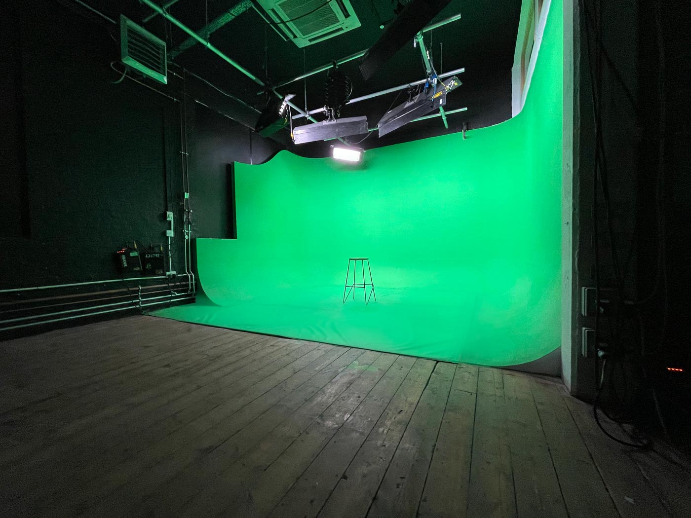 Versatile green screen studio for virtual events and presentations at Crixus Studios.