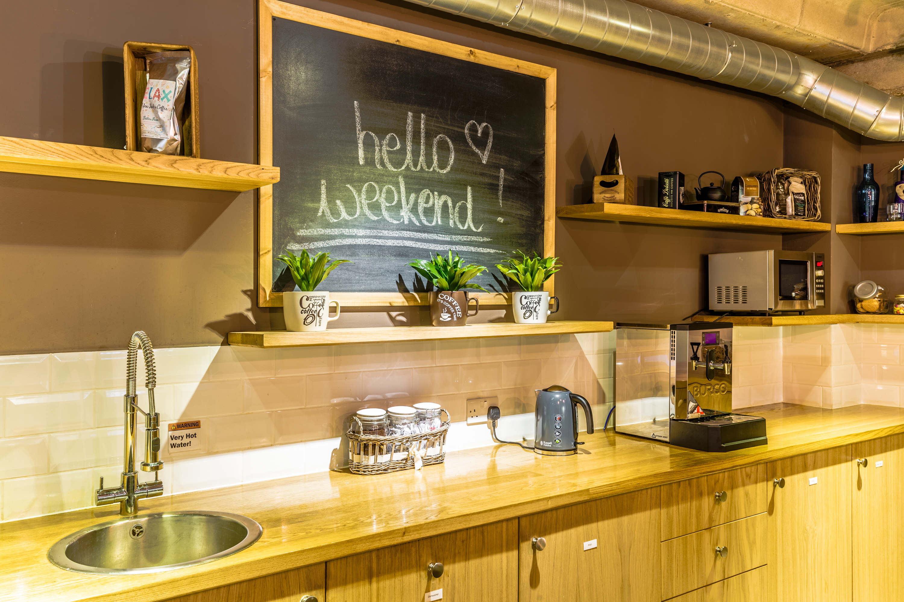 Cafe Venue refreshment area with warm wood tones, ideal for meetings and events.