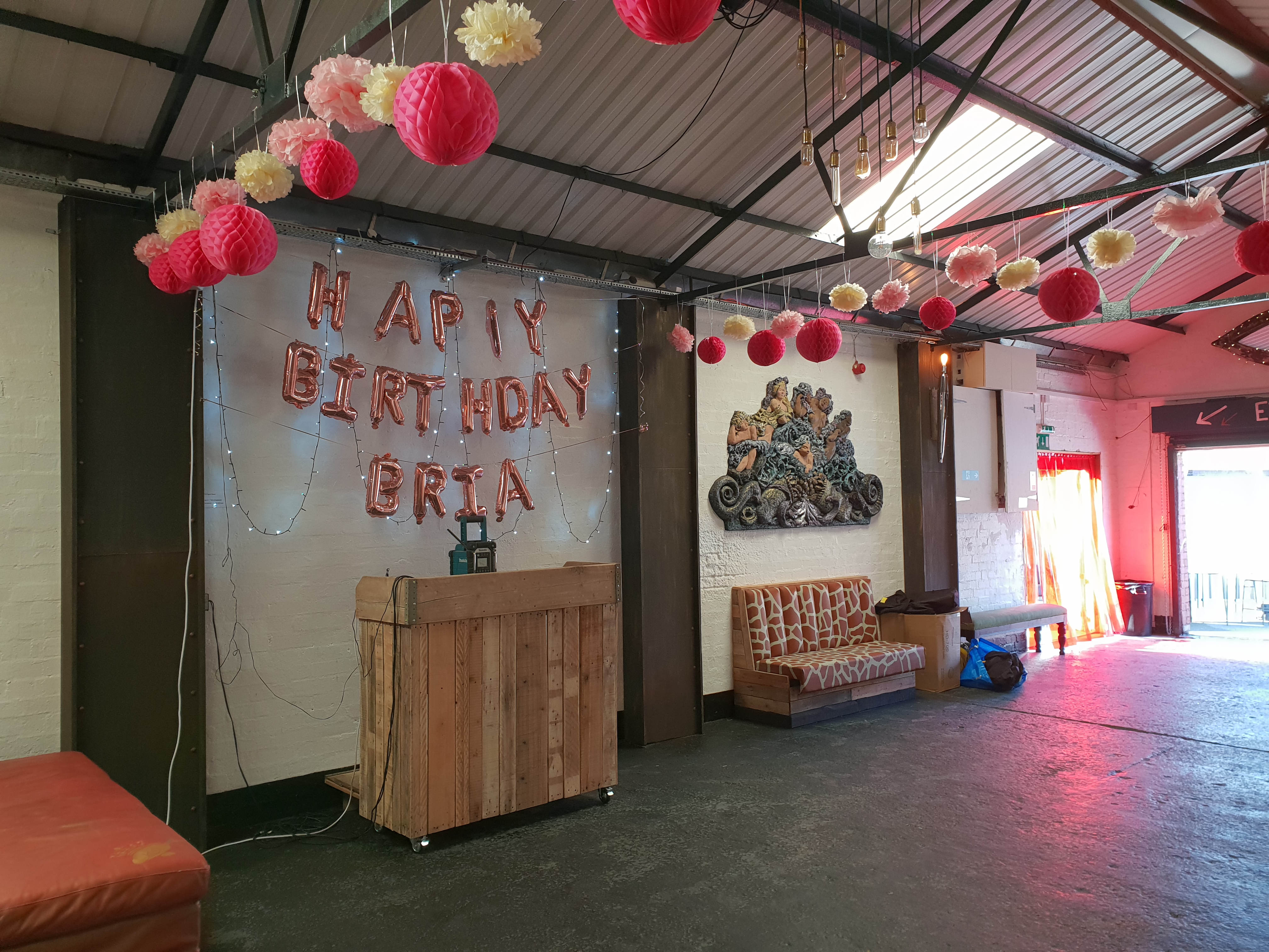 Vibrant birthday celebration in The Engine Room, featuring colorful lanterns and cozy seating.