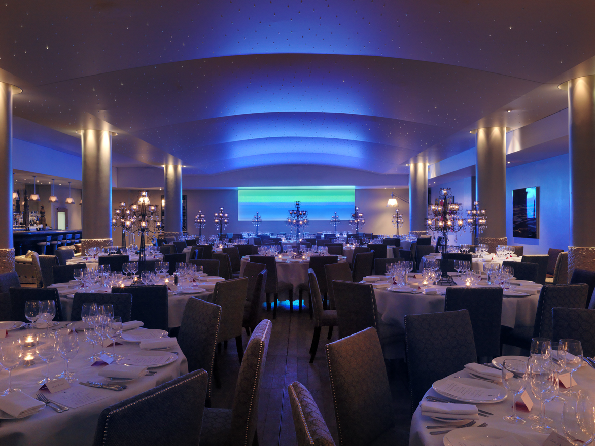 Sophisticated dining space with blue lighting at Haymarket Hotel for upscale events.
