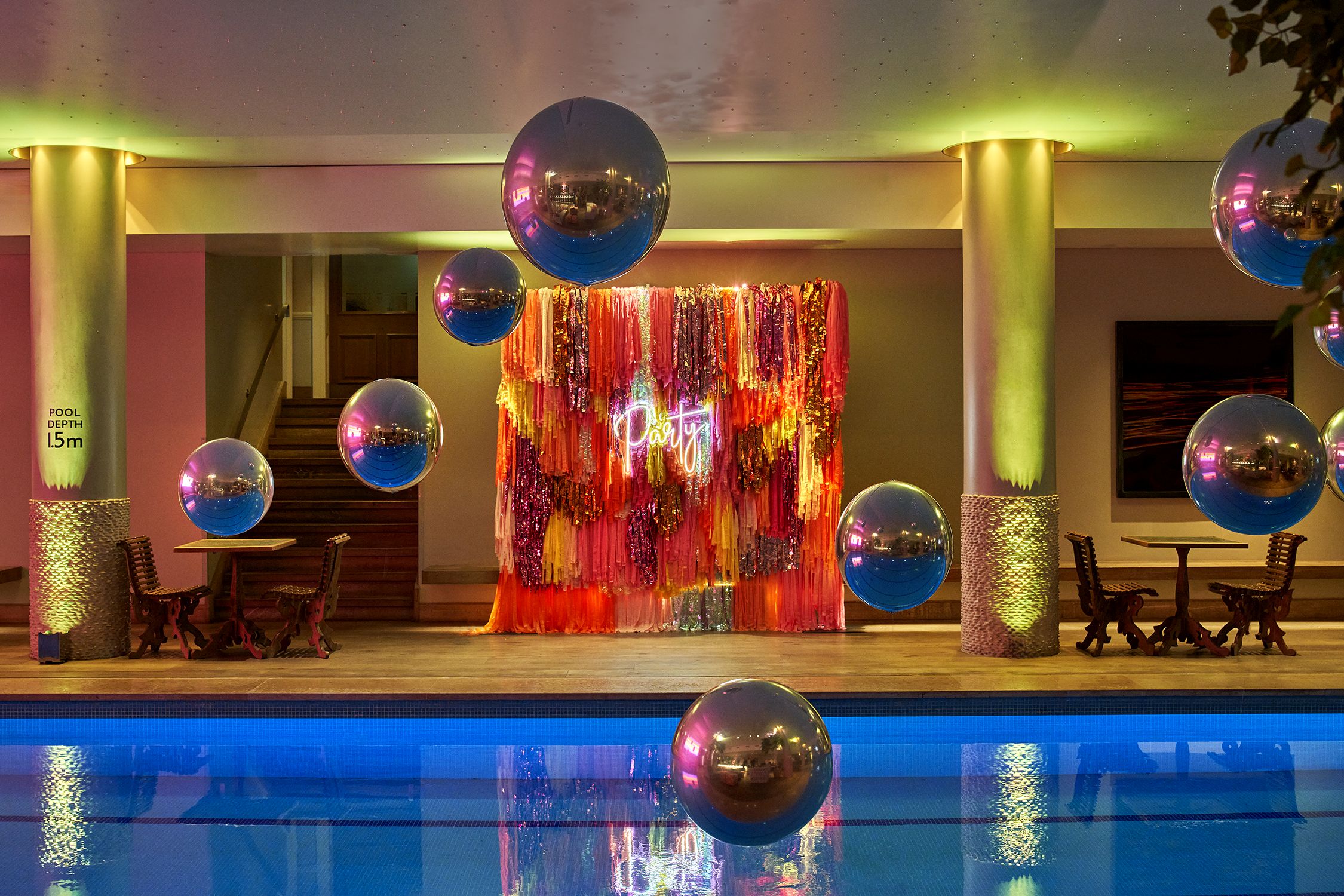 Vibrant Haymarket Hotel pool area for cocktail receptions with elegant lighting and decor.