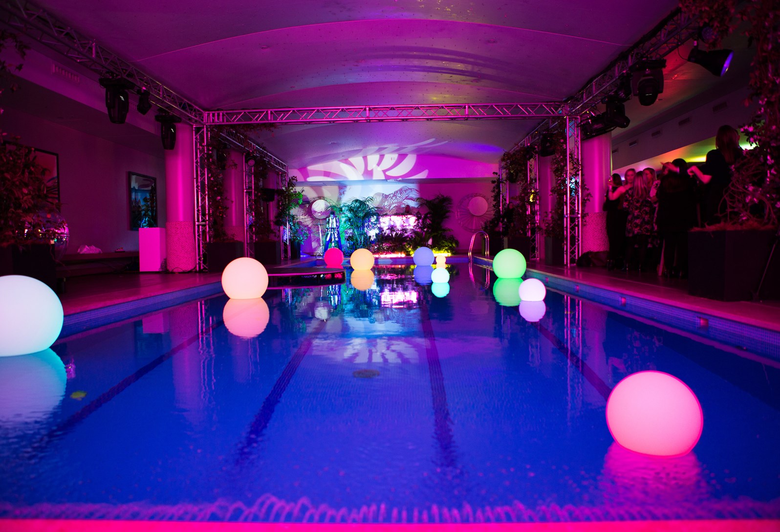 Vibrant Haymarket Hotel pool area with colorful orbs, perfect for upscale events and gatherings.