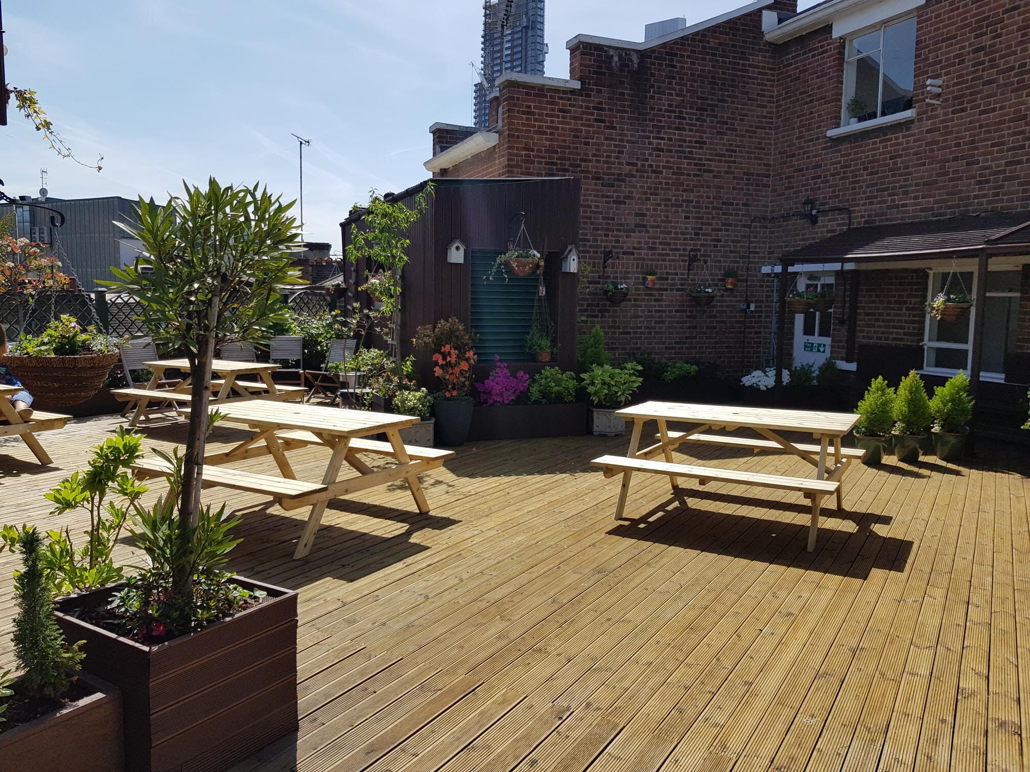 Versatile Roof Garden venue with wooden deck, ideal for casual meetings and events.