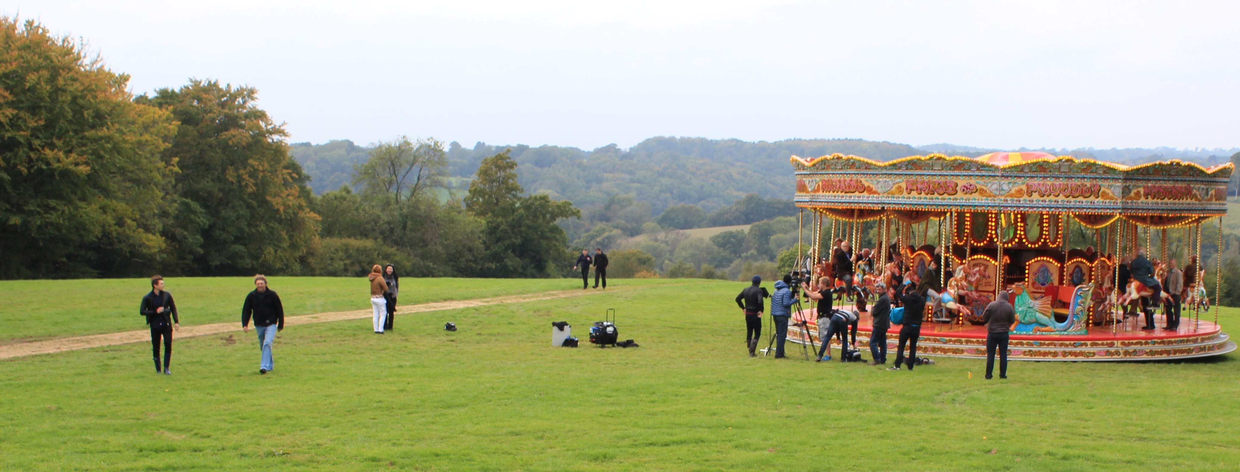 Outdoor event setup with carousel in lush greenery, perfect for memorable gatherings.