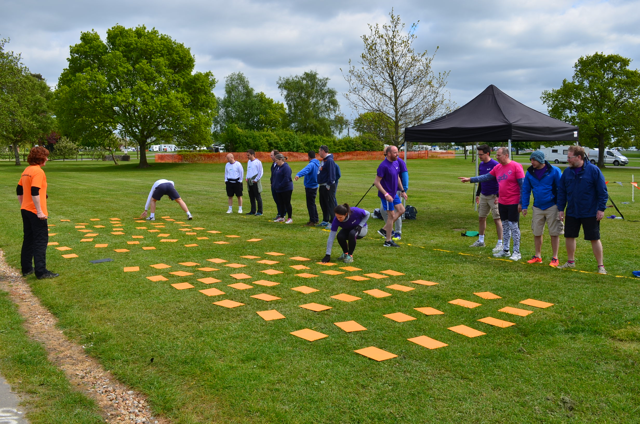 Team-building event in South of England with orange mats for teamwork and engagement.