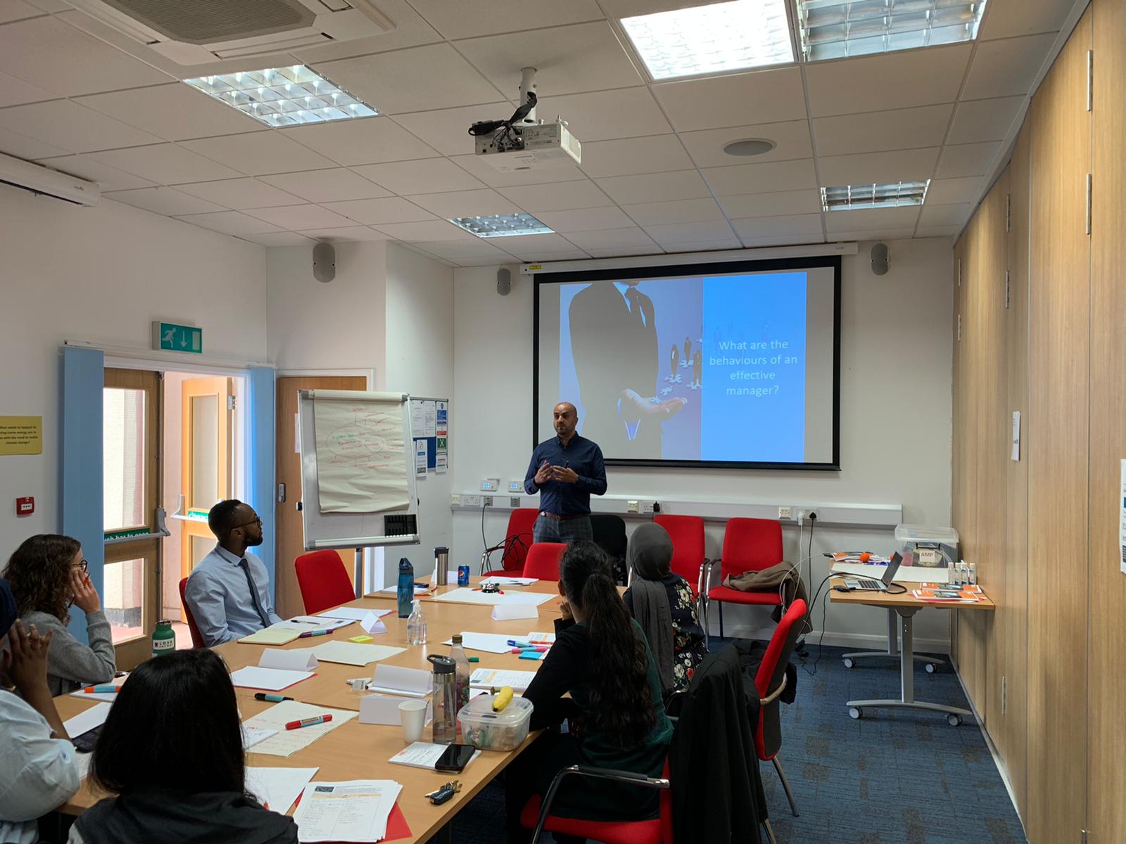 Professional meeting in HAD's Meeting Room 1 with projector for interactive presentations.