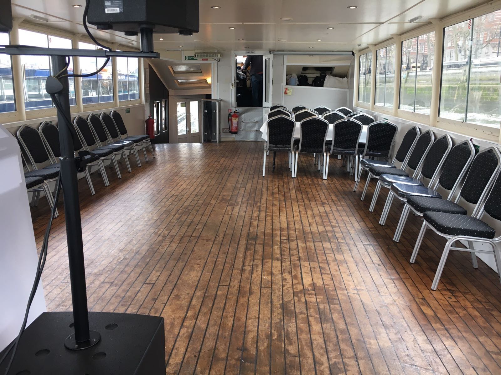 Versatile boat venue with black chairs for intimate meetings and events.