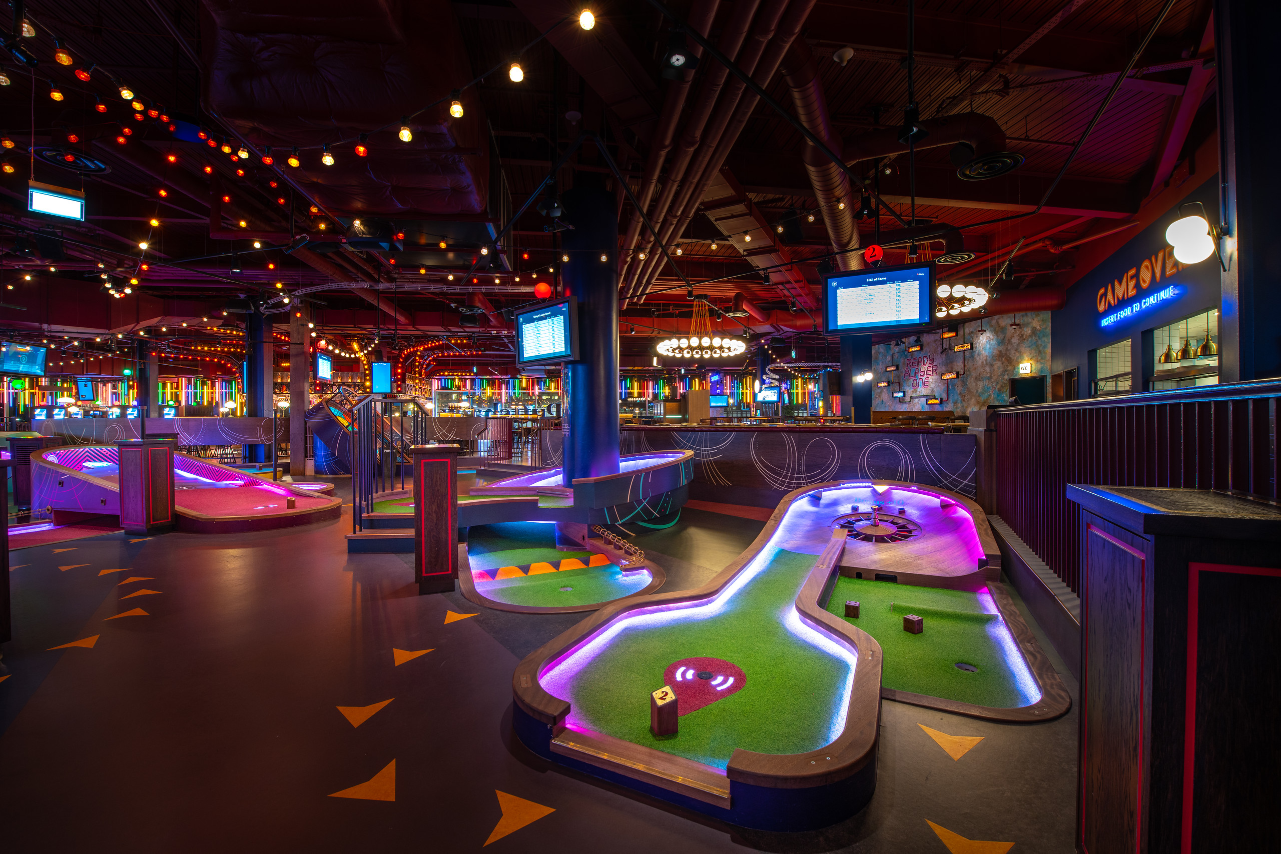 Vibrant mini-golf venue at Puttshack White City for corporate events and gatherings.
