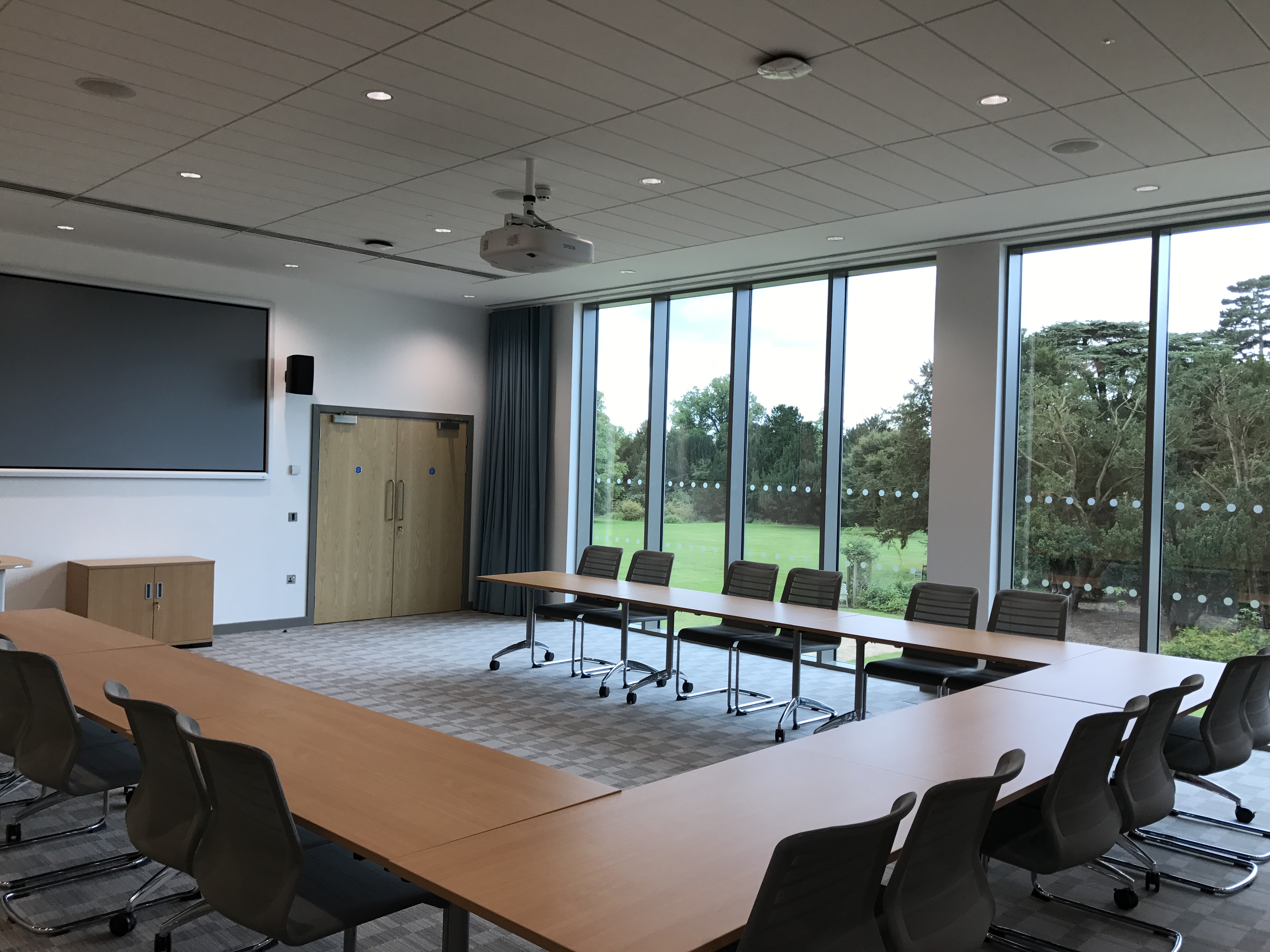 Meeting room at Queen Edith's with large table, ideal for workshops and presentations.