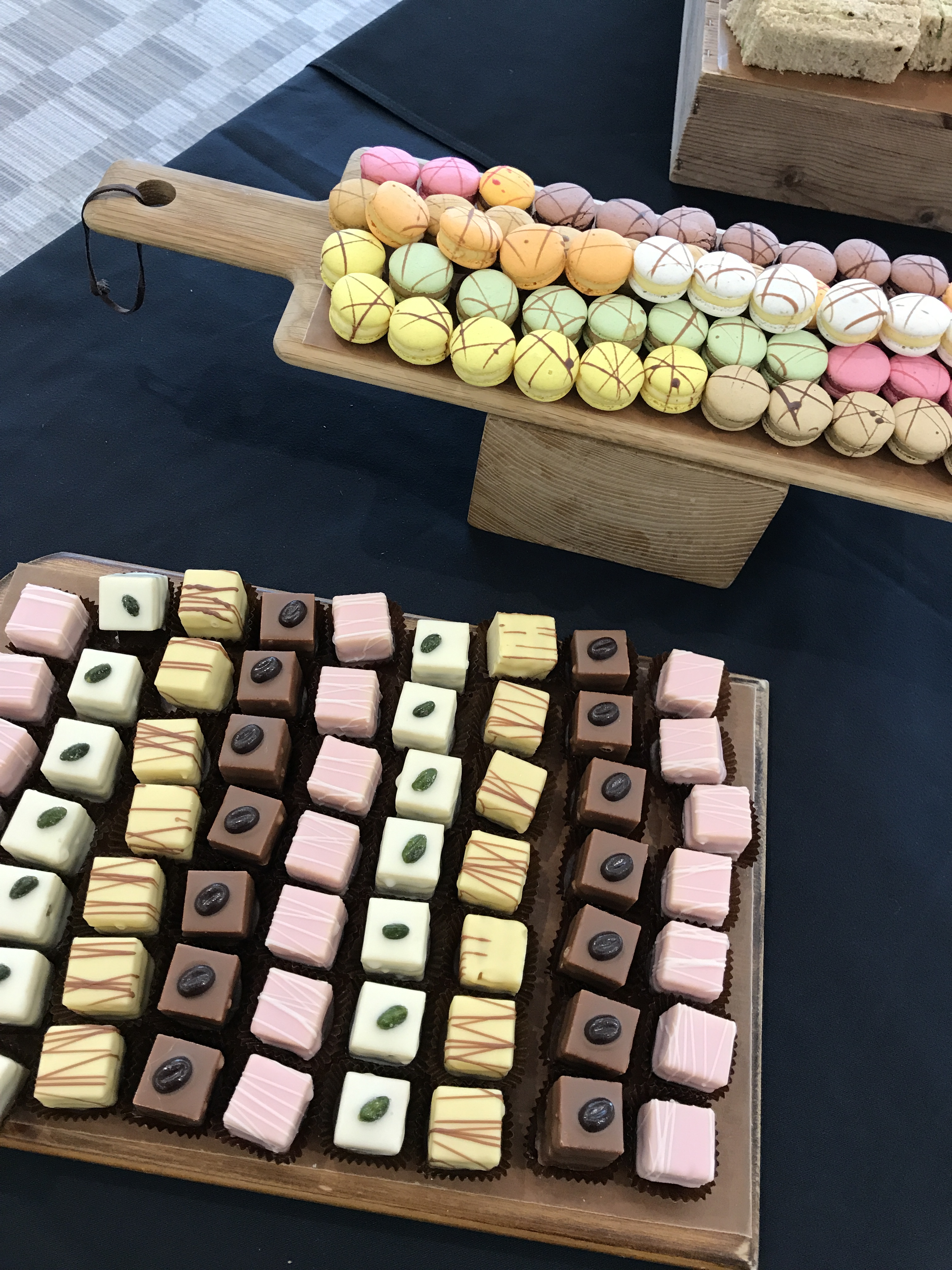Elegant dessert display with colorful macarons for upscale events and receptions.