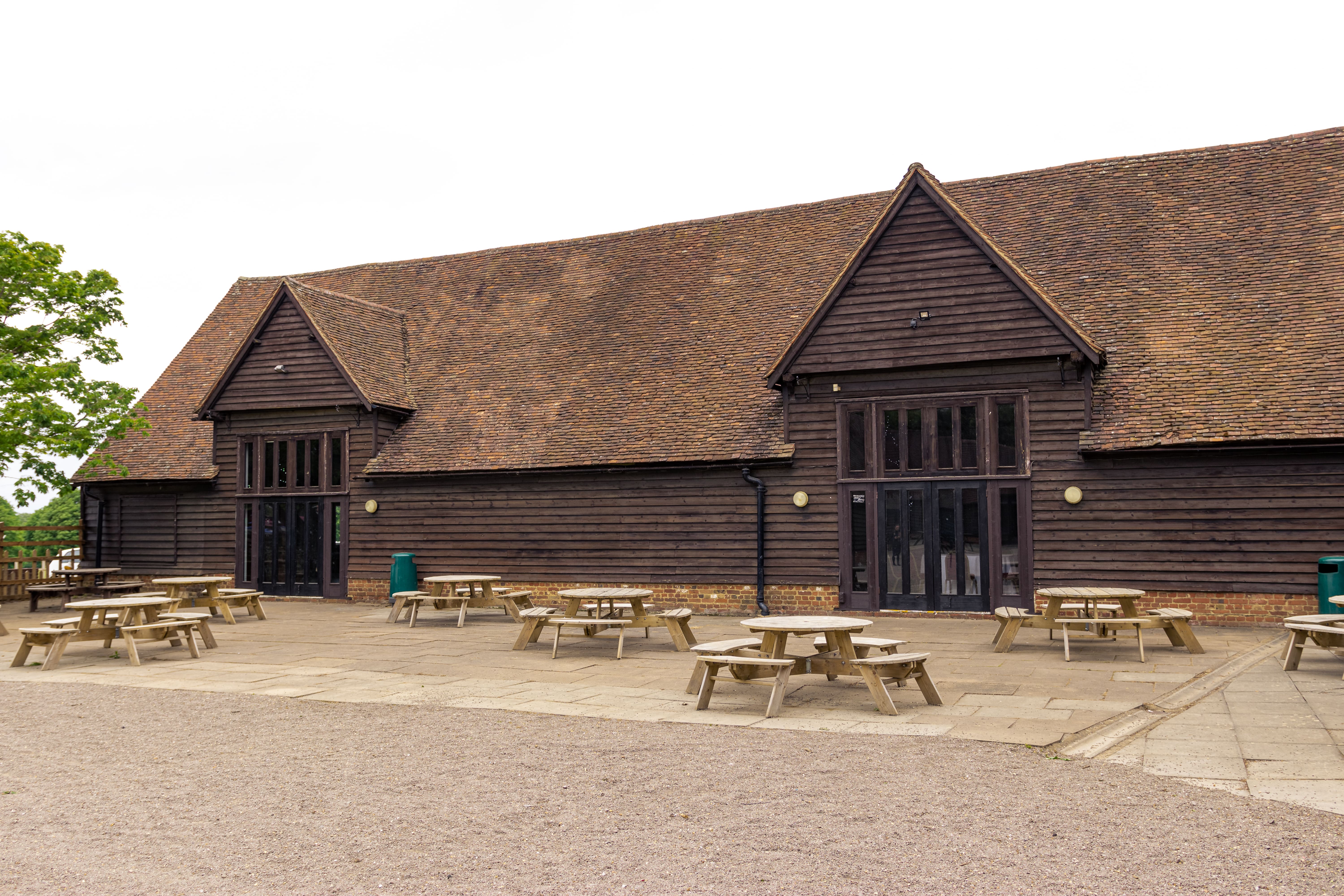 Lodge Barn at Knebworth House, rustic venue with wooden exterior for outdoor events.
