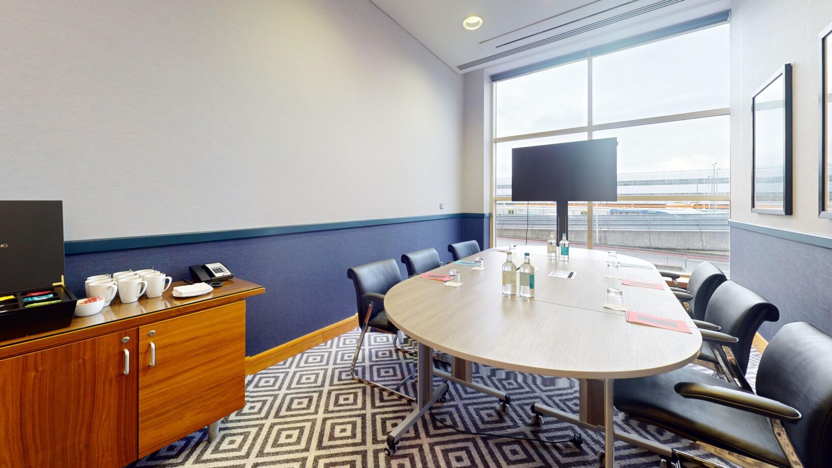 Meeting room at Sofitel London Gatwick with oval table, ideal for conferences and presentations.
